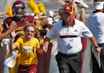 University of Minnesota vs. New Mexico State football. New Mexico State won 28-21. Head Minnesota football coach Jerry Kill, right led 10-year-old can