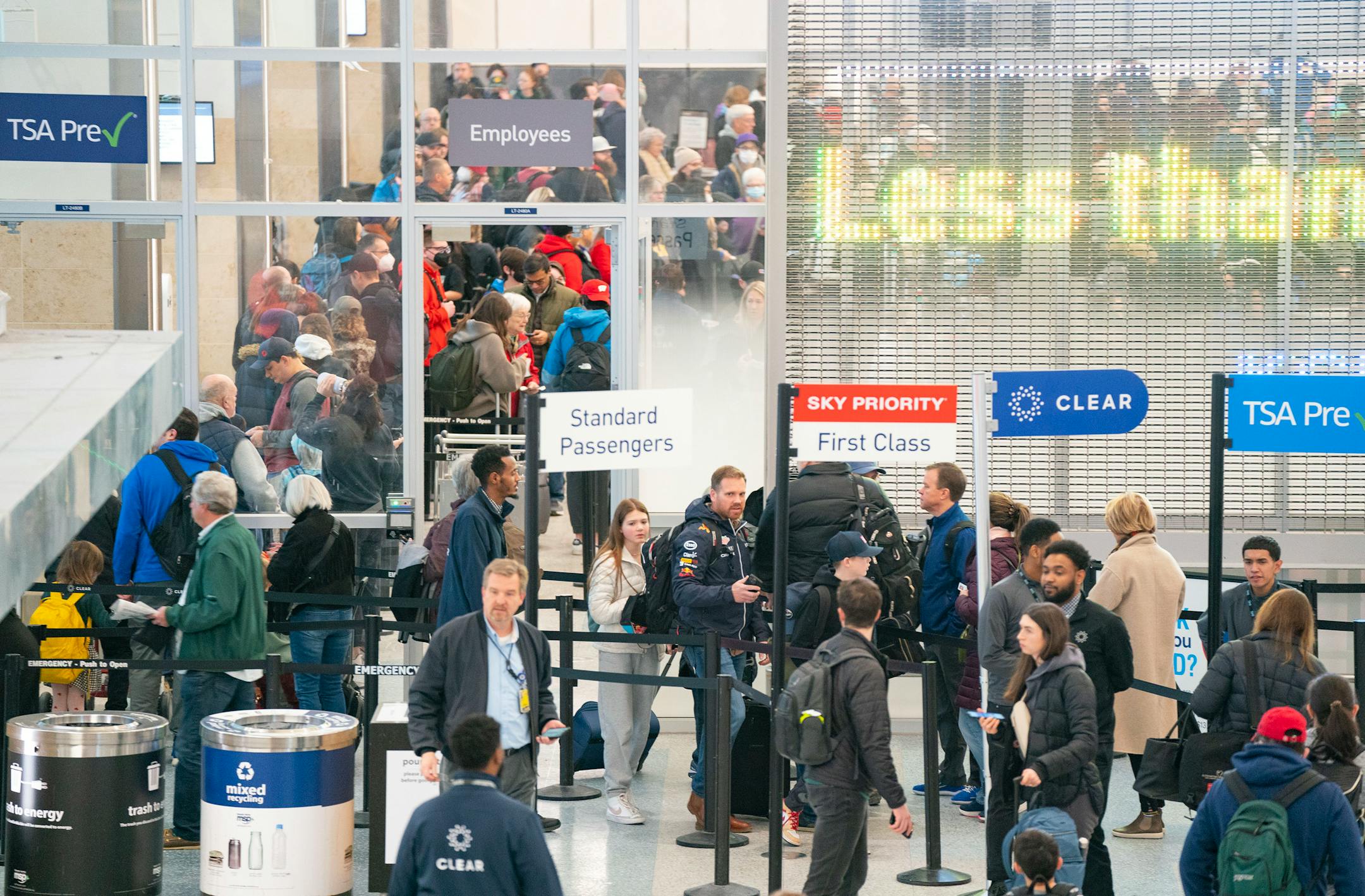 Travelers wait in line to go through security in Terminal 1 of Minneapolis-Saint Paul International Airport.