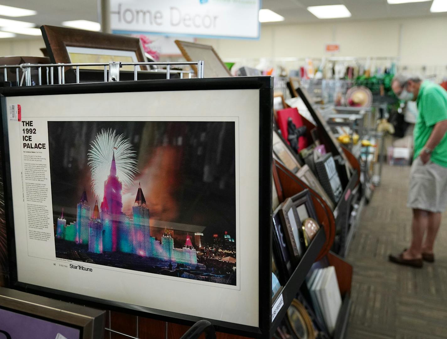 A framed photograph of the 1992 Ice Palace by Star Tribune veteran photojournalist Brian Peterson sat out for sale as customers perused the shelves at the ARC Value Village Thursday morning. ] ANTHONY SOUFFLE • anthony.souffle@startribune.com ARC Value Village donation center employees worked to keep up with the steady stream of cars packed full of items to be donated from people cleaning out their homes during the Stay Home Minnesota order to prevent the spread of COVID-19 Thursday, May 28, 202