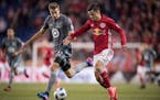Wyatt Omsberg #22 of Minnesota United FC battles for the ball with Florian Valot #22 of New York Red Bulls during a regular season game at Red Bull Ar