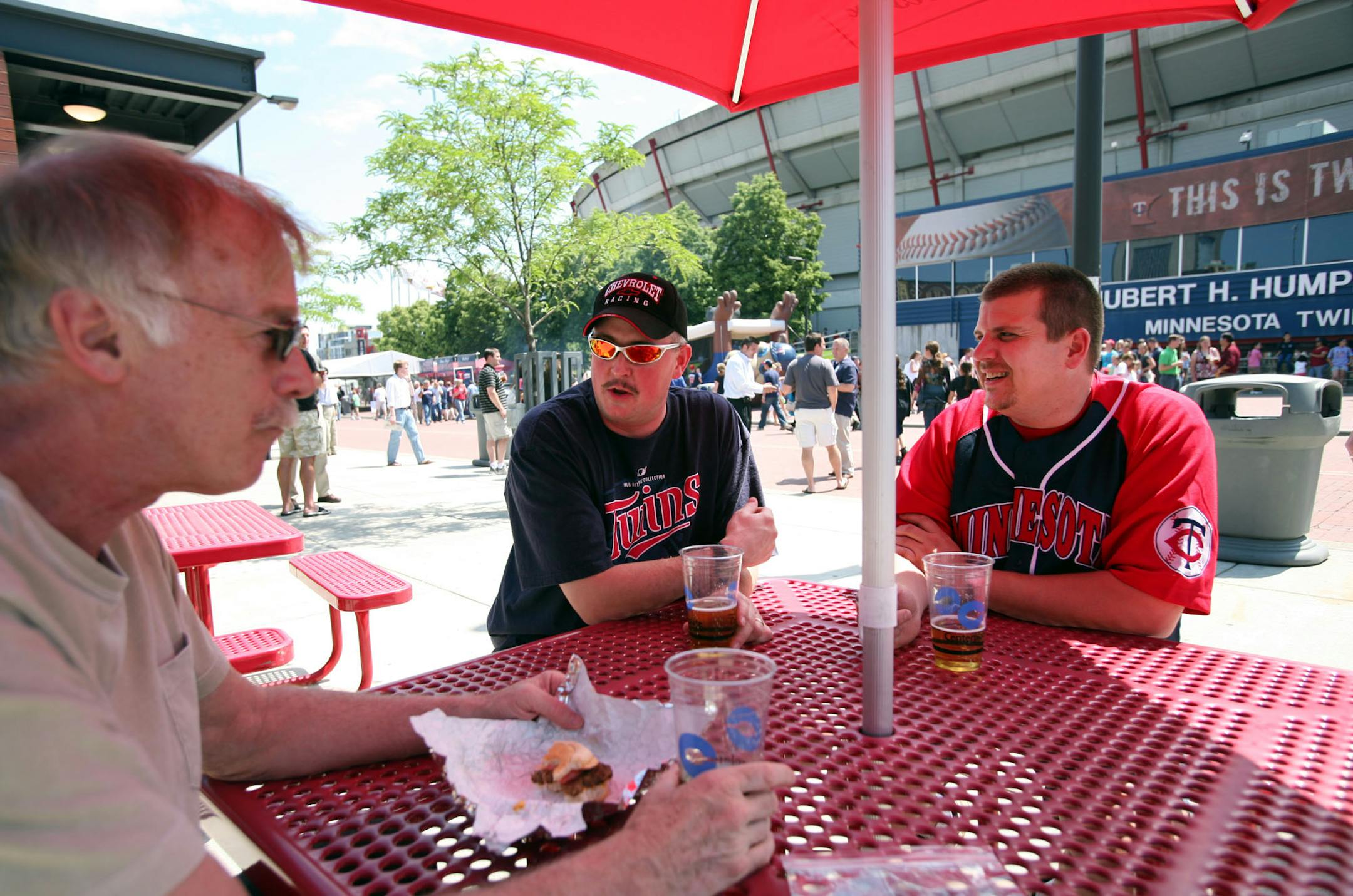 From left, Floyd Ohlson, Steve Whitaker and Kevin Koivisto discussed the sinking housing market outside the Metrodome on Thursday. Ohlson, 61, has postponed early retirement because of it.