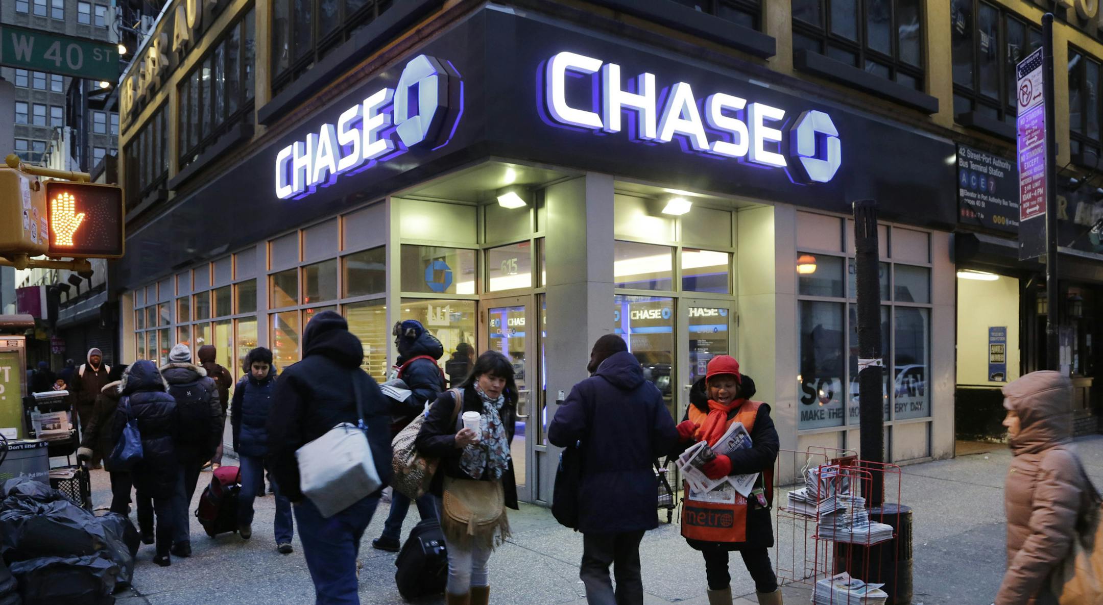 FILE - In this Jan. 14, 2015, file photo, people walk past a branch of Chase Bank, in New York. JPMorgan Chase & Co. (JPM) on Wednesday, April 13, 2016, reported first-quarter earnings. (AP Photo/Mark Lennihan, File)