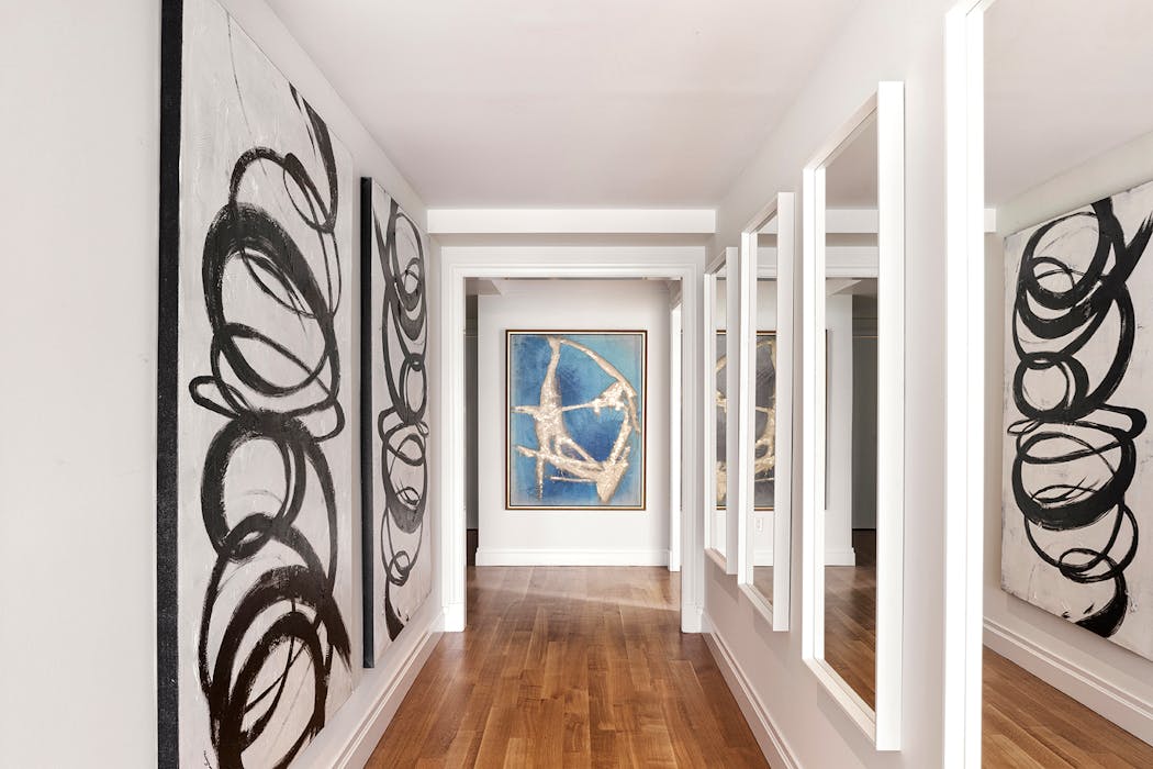 A series of mirrors helps to elongate a hallway.