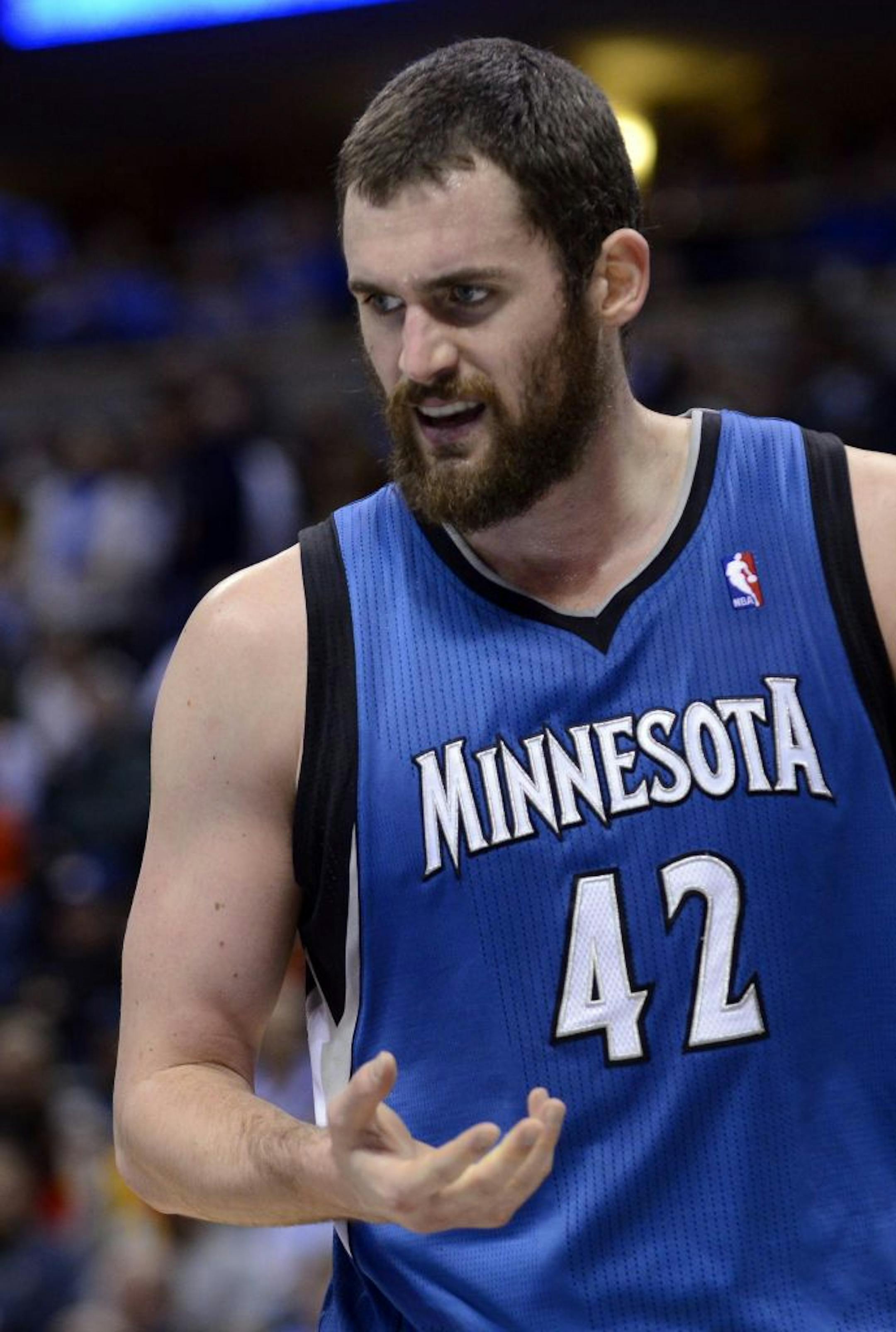 Minnesota Timberwolves forward Kevin Love reacts to his injured right hand.