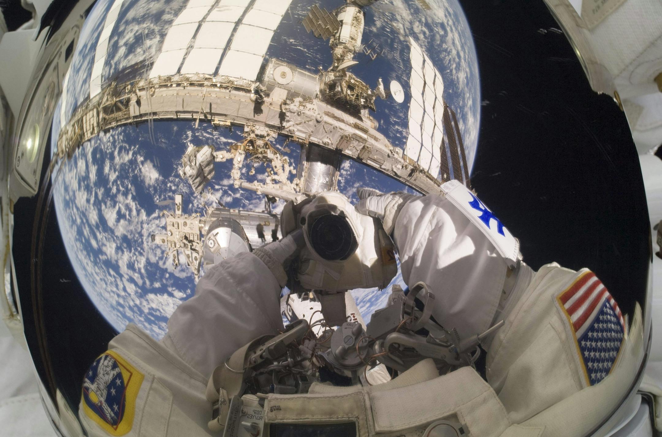 In this May 17, 2010 photo provided by NASA, astronaut Garrett Reisman, STS-132 mission specialist, takes a self portrait into his helmet visor while participating in the first of three spacewalks scheduled for the space shuttle Atlantis crew and their Expedition 23 hosts.