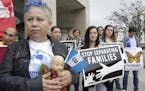 In this May 17, 2016, file photo, Guatemalan immigrant Amariliz Ortiz holds a doll as she joins families impacted by the immigration raids during a ra