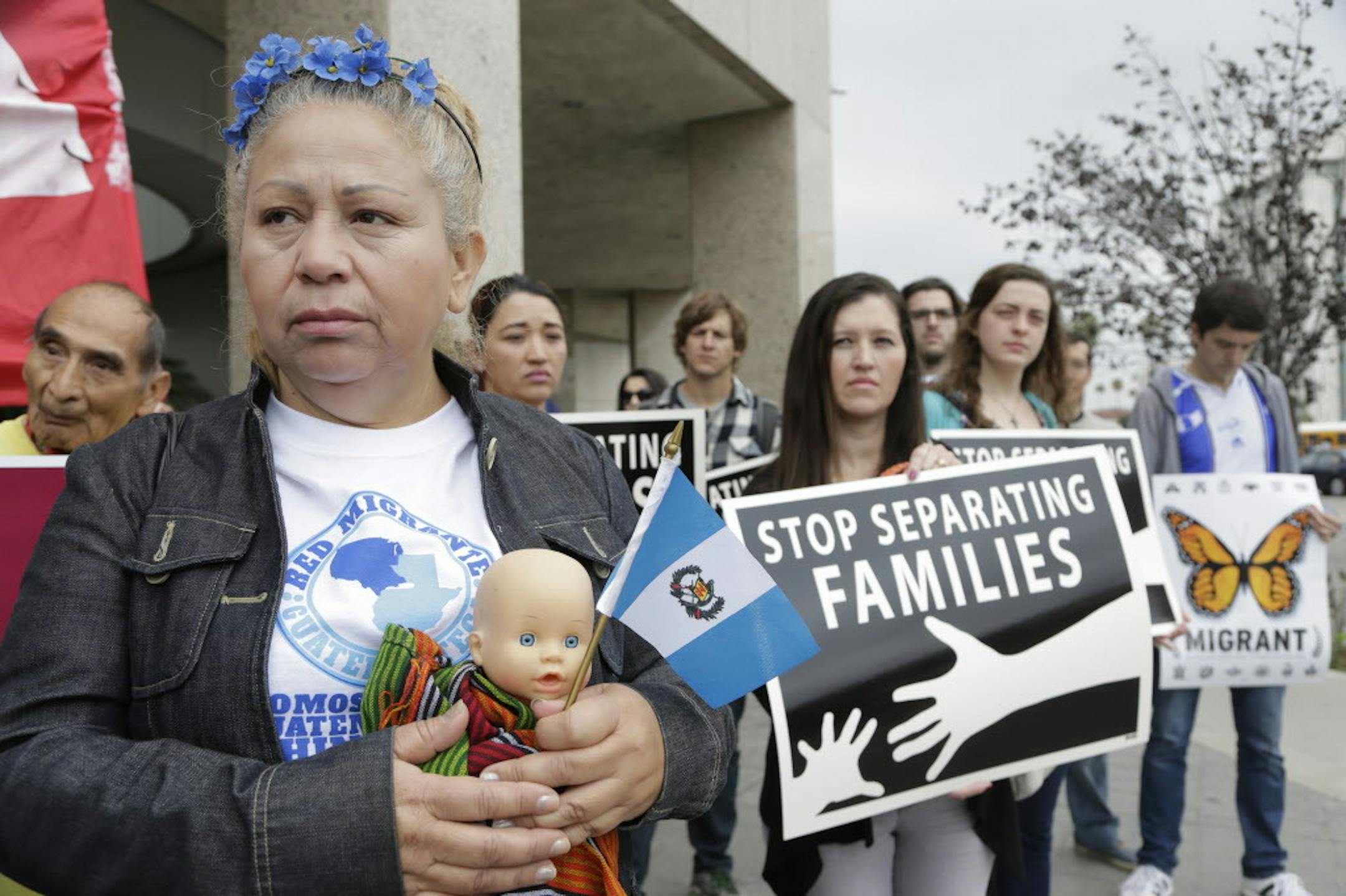 In this May 17, 2016, file photo, Guatemalan immigrant Amariliz Ortiz holds a doll as she joins families impacted by the immigration raids during a rally with Members of the Coalition for Humane Immigrant Rights of Los Angeles, CHIRLA, outside the ICE Metropolitan Detention Center in downtown Los Angeles. Immigrant advocate groups claim that more than 100 people had been taken into custody by federal immigration officials in Southern California on Thursday, indicating a &#x201c;coordinated sweep