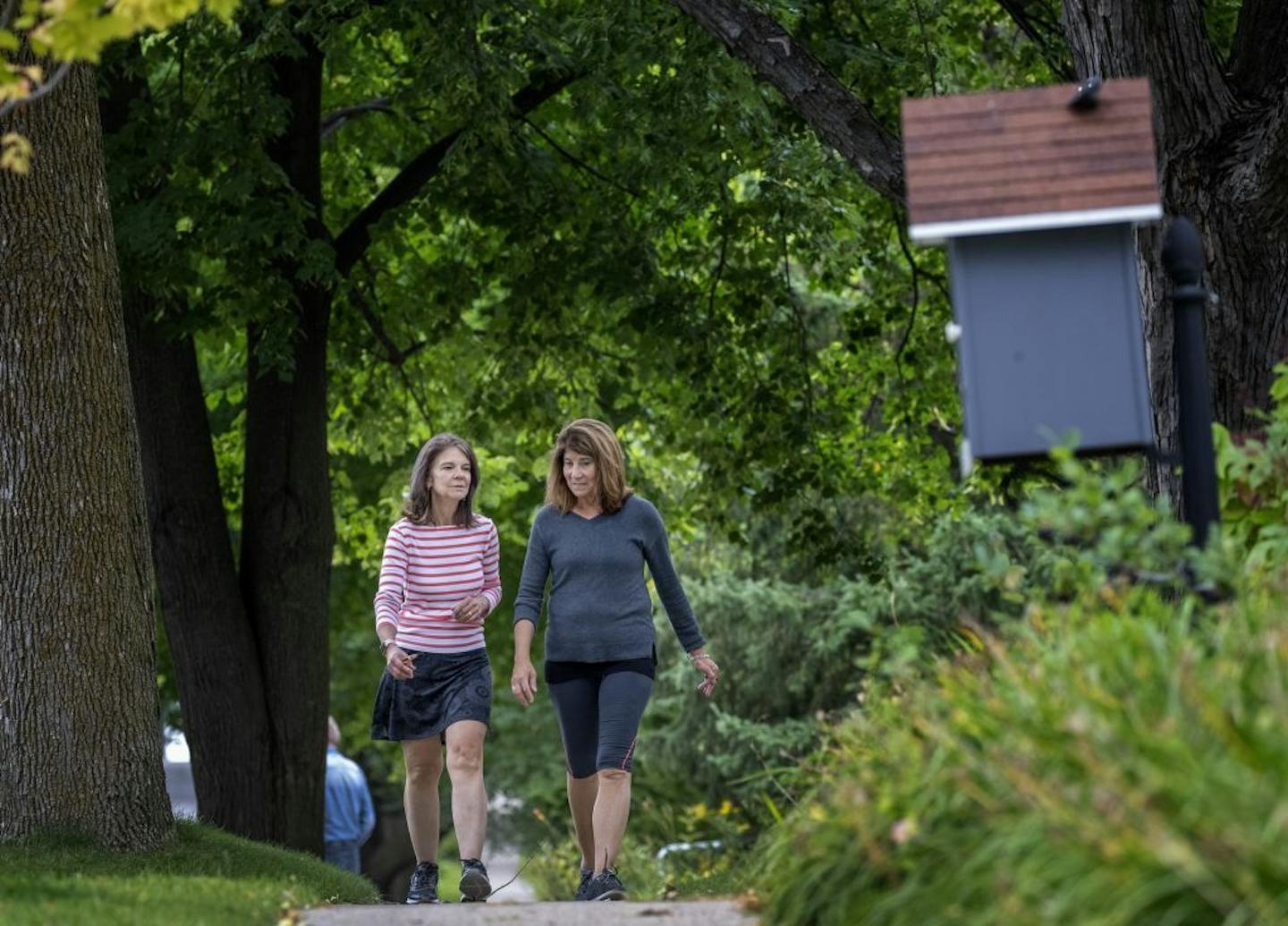 Kari Rotman and Katie Dorn walked on a sidewalk in Excelsior, MN.