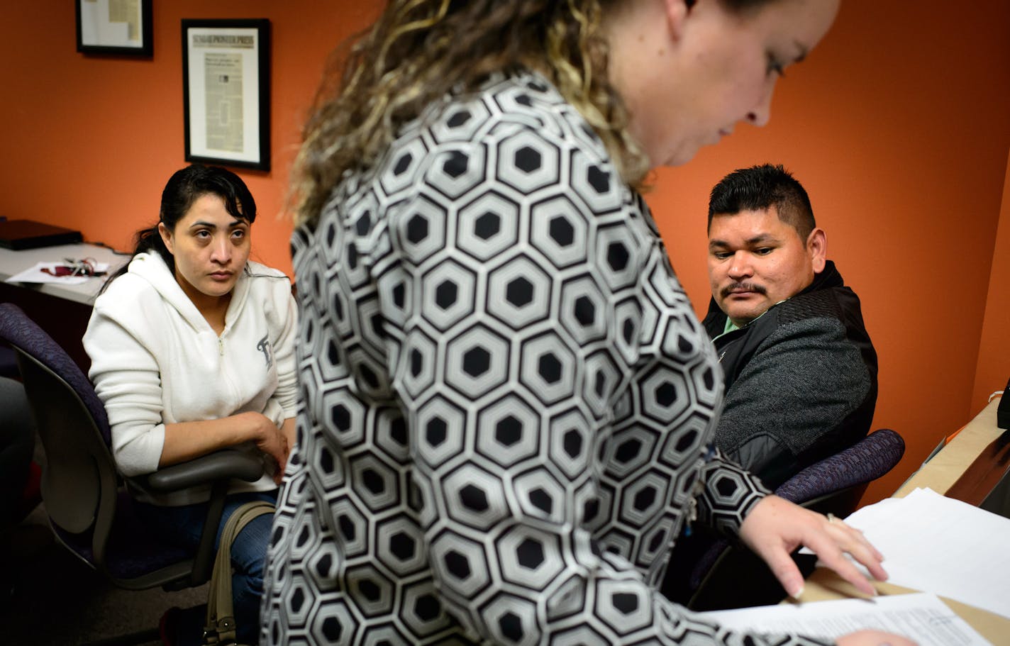 Rosa Zavala and her husband Jose Salmeron of Bloomington looked on as outreach program supervisor Sara Casey checked over their completed MNsure application. Portico HealthNet in St. Paul was taking paper applications for MNsure Monday as the website was overloaded. ] GLEN STUBBE * gstubbe@startribune.com Monday, March 31, 2014.