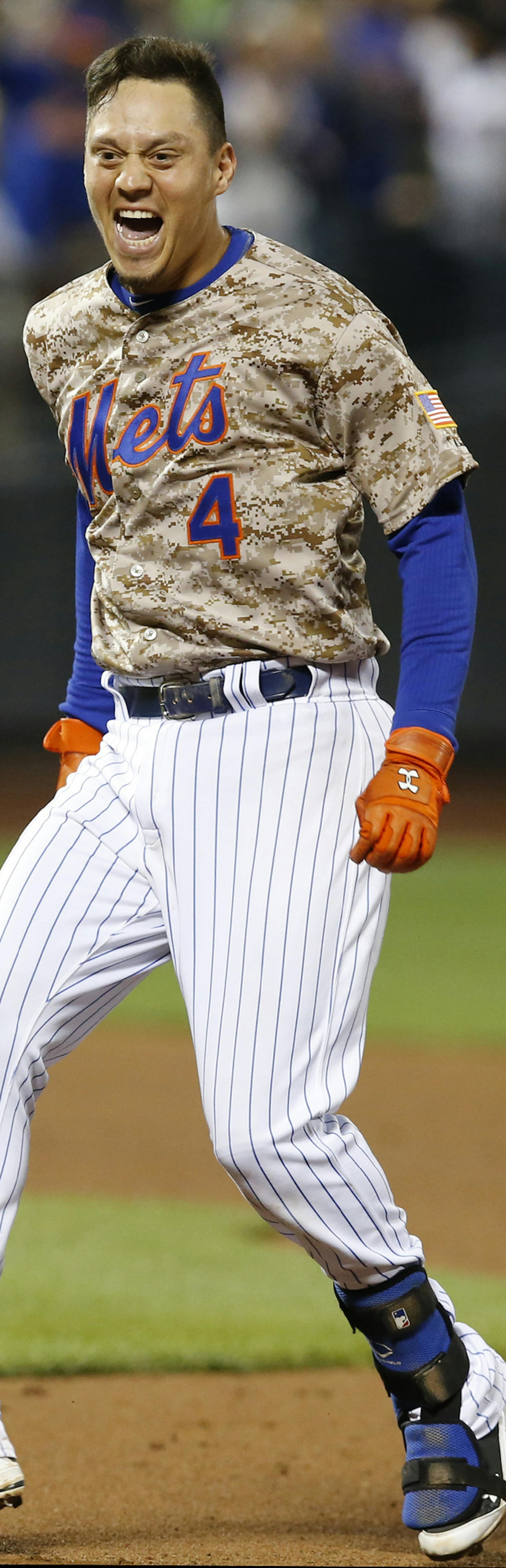 New York Mets Wilmer Flores (4) reactD after hitting an 11th-inning, walk-off, RBI single lifting the Mets to a 4-3 victory over the Toronto Blue Jays in a baseball game in New York, Monday, June 15, 2015. The Mets victory ended the Jays winning streak at 10. (AP Photo/Kathy Willens)