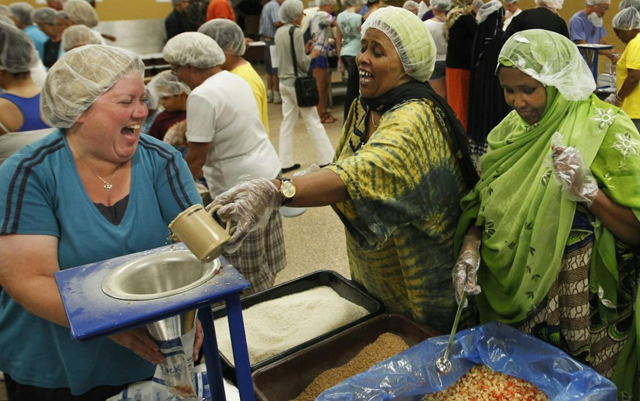 From left, Lori Swedeen worked with two Somali volunteers, Fadumo Egal and Malyun Buale, at Feed My Starving Children's office in Coon Rapids.