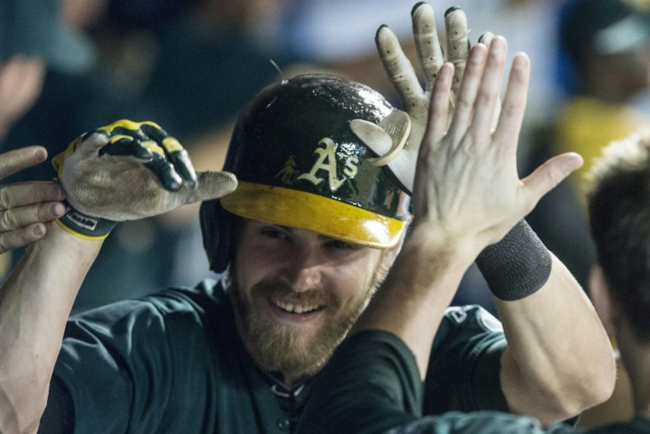 Oakland Athletics Josh Reddick celebrates in the dug out after hitting a three run homer off Toronto Blue Jays pitcher Juan Perez during sixth inning AL baseball action in Toronto on Friday August 9, 2013. THE CANADIAN PRESS/Chris Youngof a baseball game in Toronto on Friday, Aug. 9, 2013.