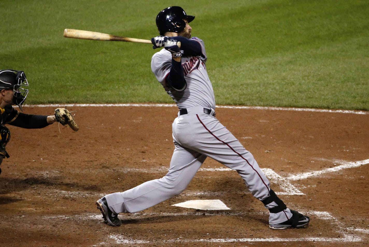 Minnesota Twins' Joe Mauer (7) hits a solo-home run off Pittsburgh Pirates relief pitcher Antonio Bastardo during the thirteenth inning of a baseball game in Pittsburgh Wednesday, May 20, 2015. The Twins won 4-3. (AP Photo/Gene J. Puskar)