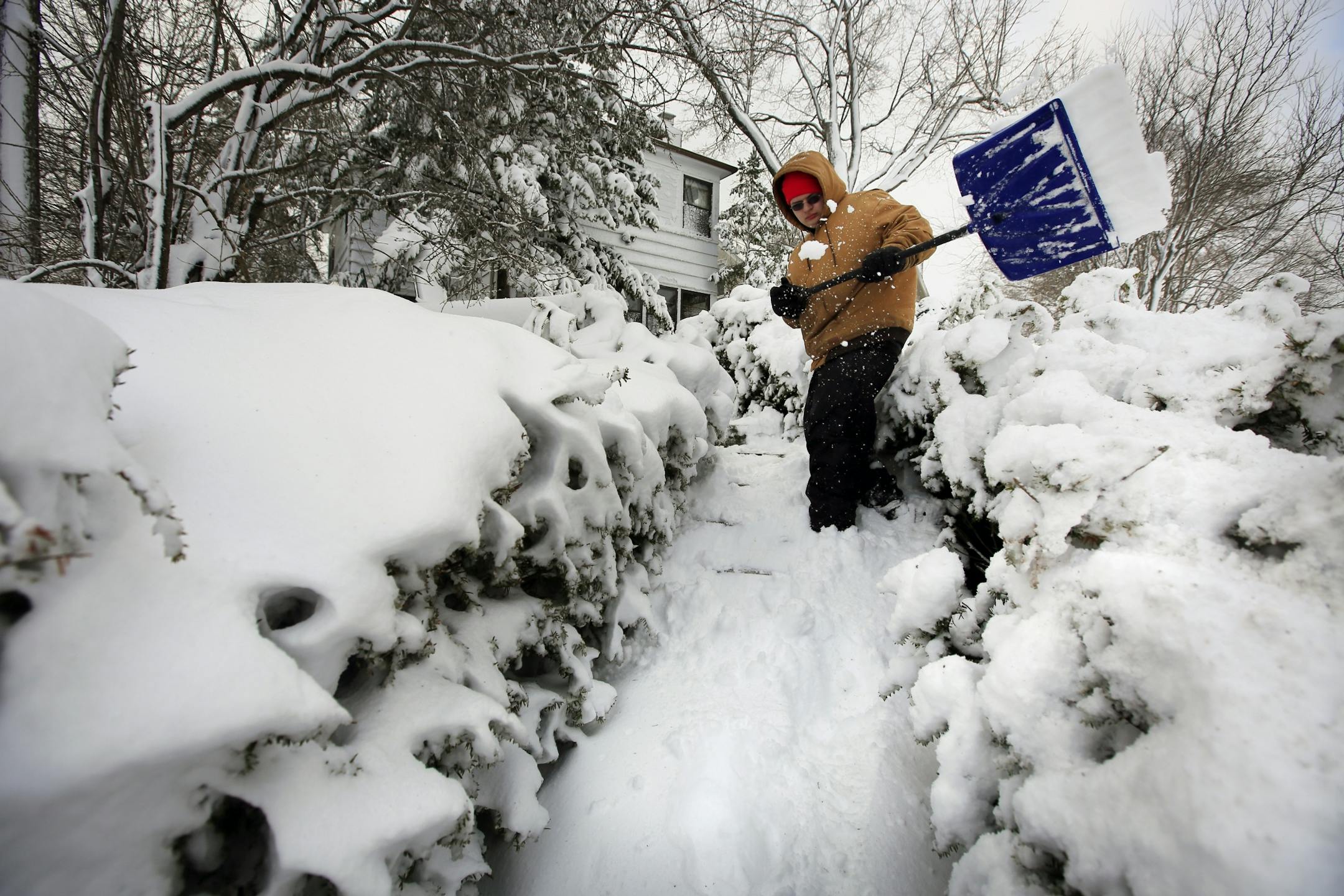 Another wintry blast buried Minnesota, disrupted travel and closed schools. Here, Jeff Daniels clear the snow from a house in the south shore of Lake Nokomis. They work for Beaks Landscape and Lawn Care. The National Weather Service says 22 inches of snow has fallen in the Lake County community of Two Harbors, with 20 inches at Lake Nichols in St. Louis County. The Twin Cities totals stretched from 5-11 inches.