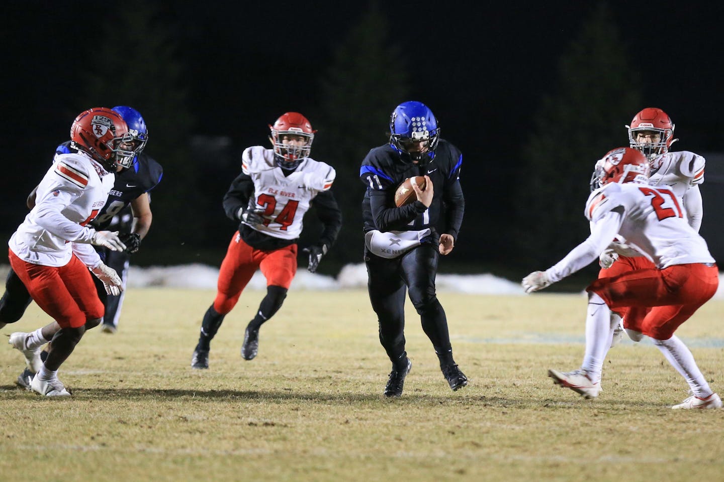 Rogers' Zach Evenson (11) looks a running lane against Elk River in a Class 5A section championship on Nov. 20. Section 6 re-shuffled its schedule so that No. 1 seed Rogers and No. 2 Elk River could play for the title.