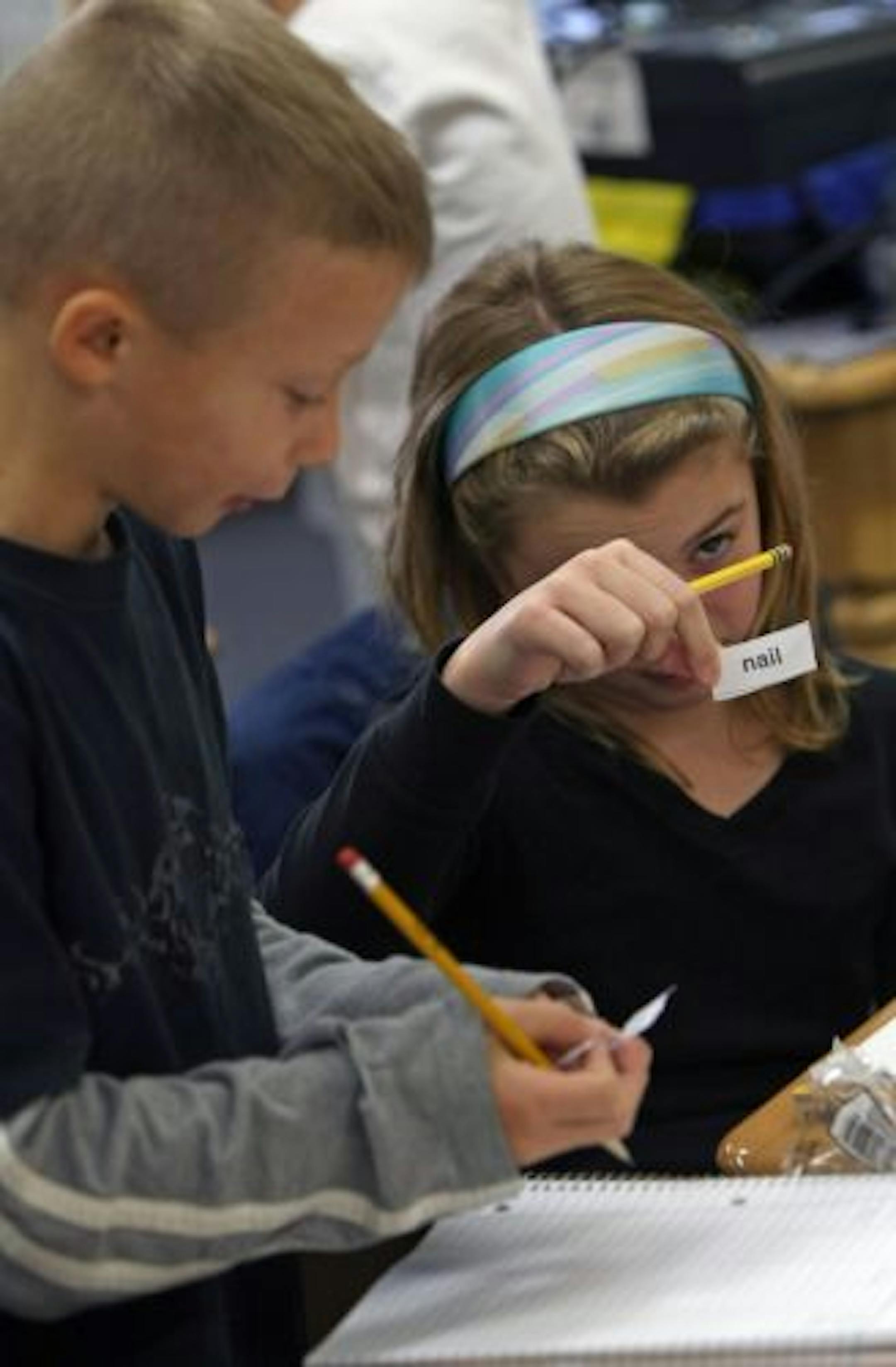 (left to right) Students Charlie Kashmark and Madison Dorival worked on word problems during Brandie Ahlstrand's class.