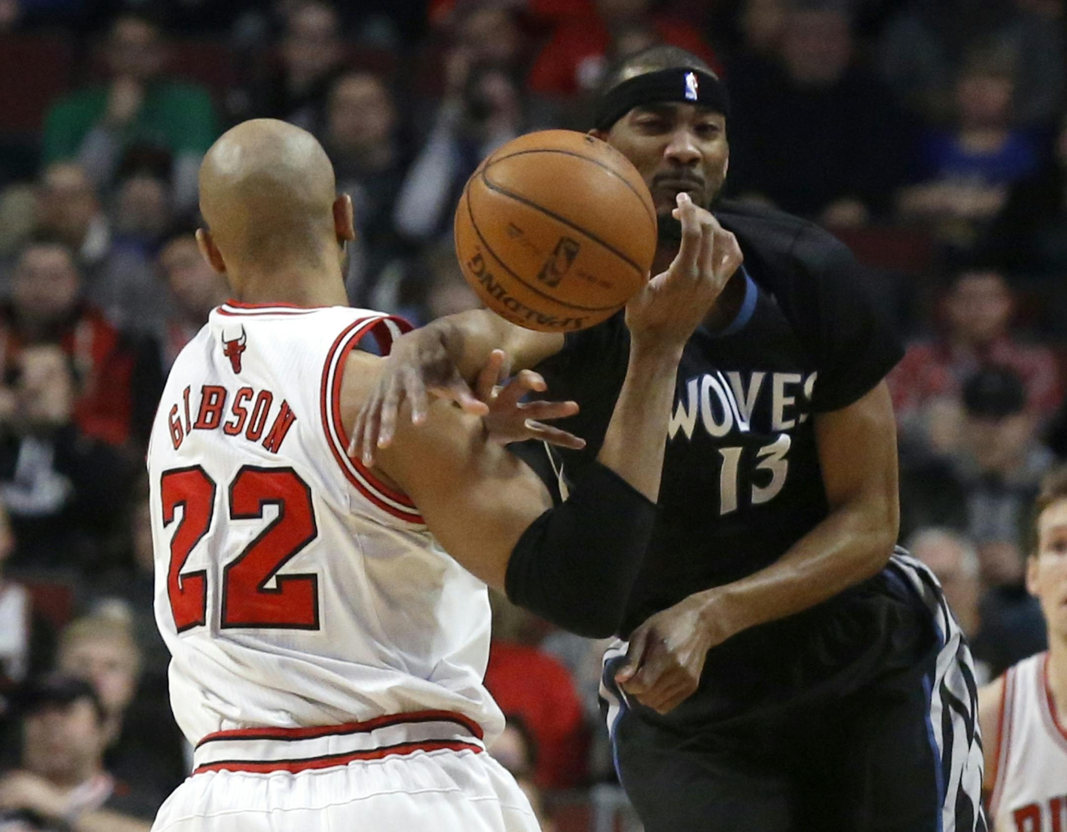 Minnesota Timberwolves forward Corey Brewer (13) knocks the ball from the hands of Chicago Bulls forward Taj Gibson (22) during the first half of an NBA basketball game, Monday, Jan. 27, 2014, in Chicago.