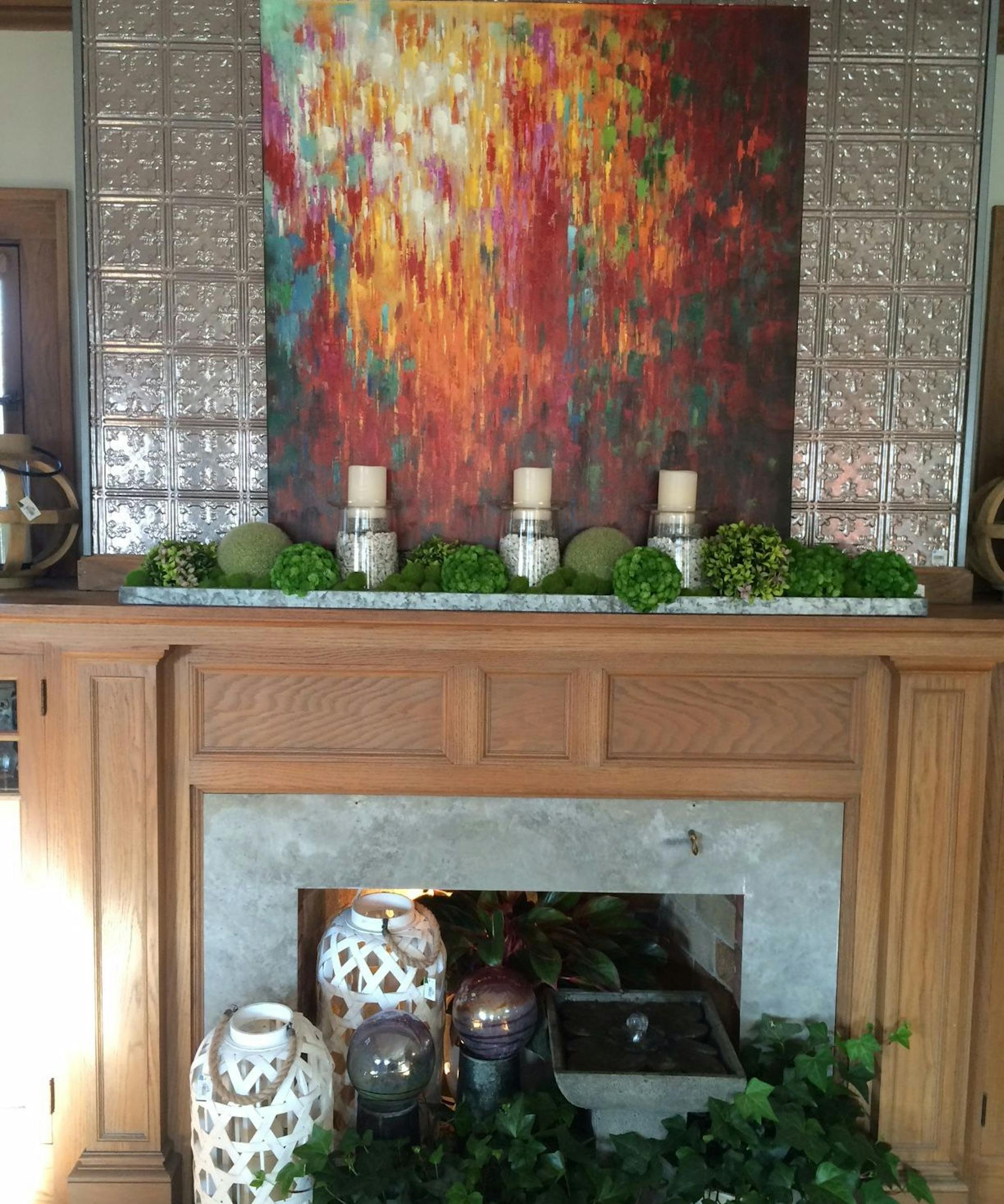 Water fountain, outdoor garden globes and ivy pots add spring accents to the living room hearth.