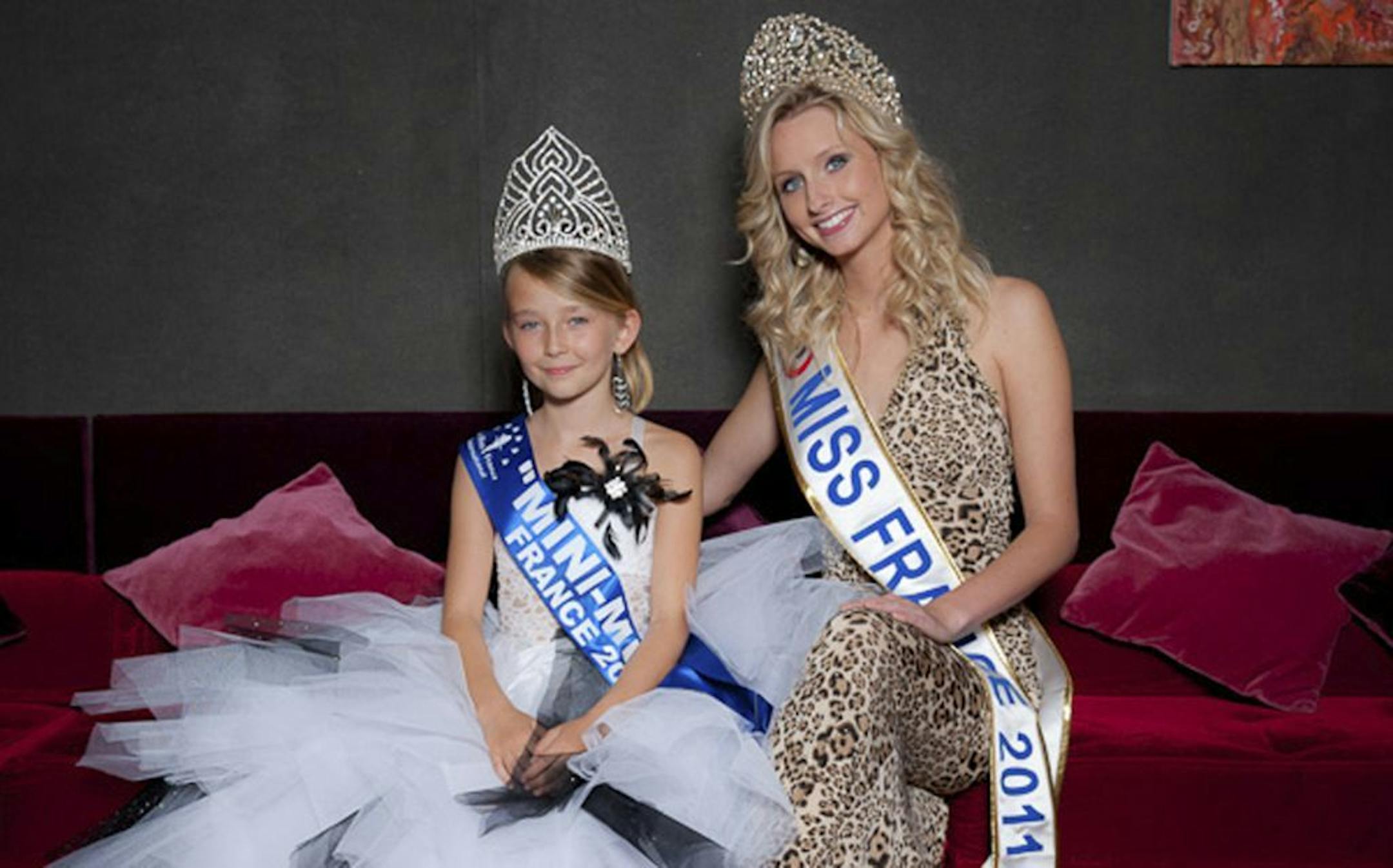 This undated photo provided by the Mini Miss committee shows Oceane Scharre, 10, elected Mini Miss France 2011, left, and Miss France 2011 Mathilde Florin. France's Senate voted Tuesday night, Sept. 17, 2013, to ban beauty pageants for children under 16, in an effort to protect children � especially girls � from being sexualized too early. Anyone who enters a child into such a contest would face up to two years in prison and 30,000 euros in fines, according to the measure. (AP Photo/Mini Miss Co