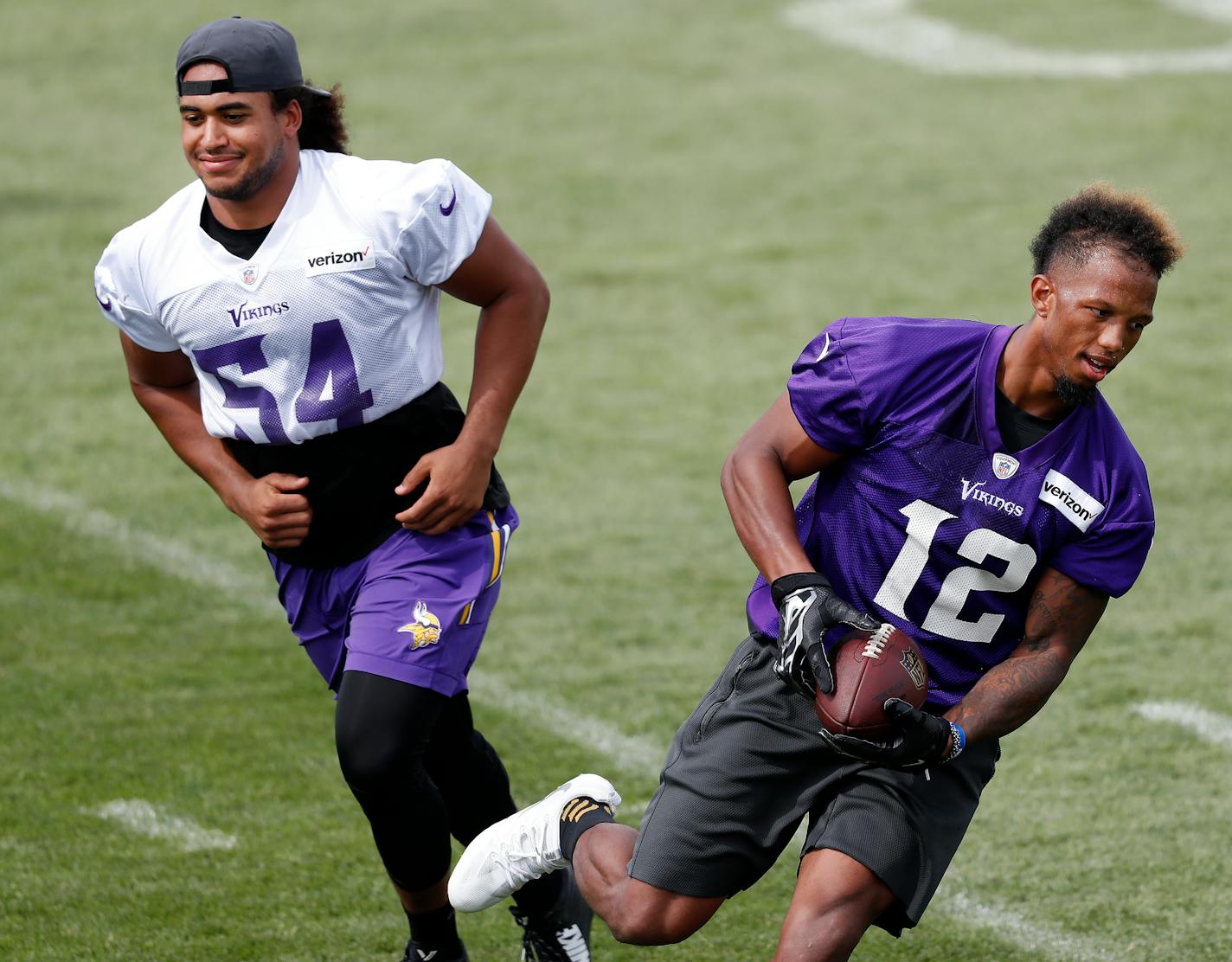 Linebacker Eric Kendricks (54, shown with receiver Chad Johnson) was singled out by Vikings coach Mike Zimmer as being much more comfortable than he was last season, when he led the team in tackles.