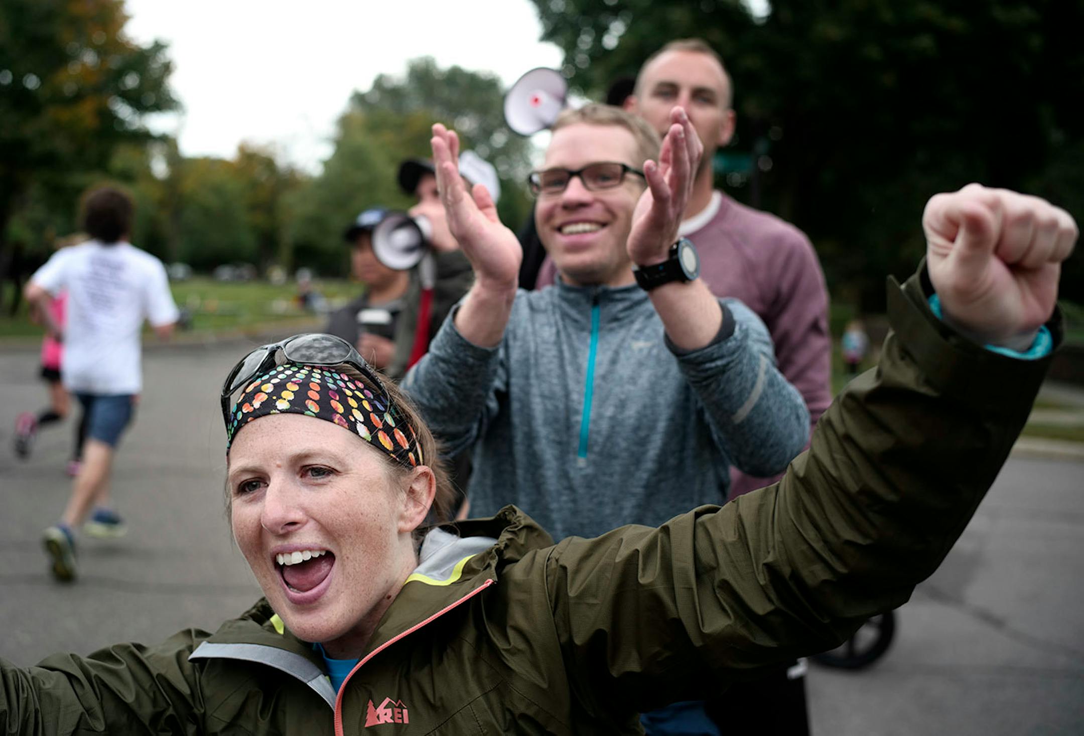 Shanna Braun and Chris Lyon of Capitol City Runners cheered their friends on near the 23-mile marker.