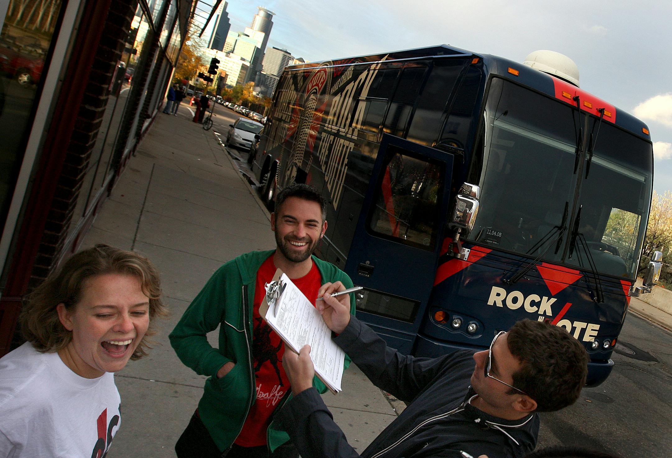 Willa Brown, 23, left, of Washington D.C., worked the Rock the Vote effort, pleased to see Chuck Dusbabeck, 29, St. Paul, signing up. Rock the Vote's Road Trip bus also has computer kiosks to help with absentee ballots and to educate users about key issues and the election process.