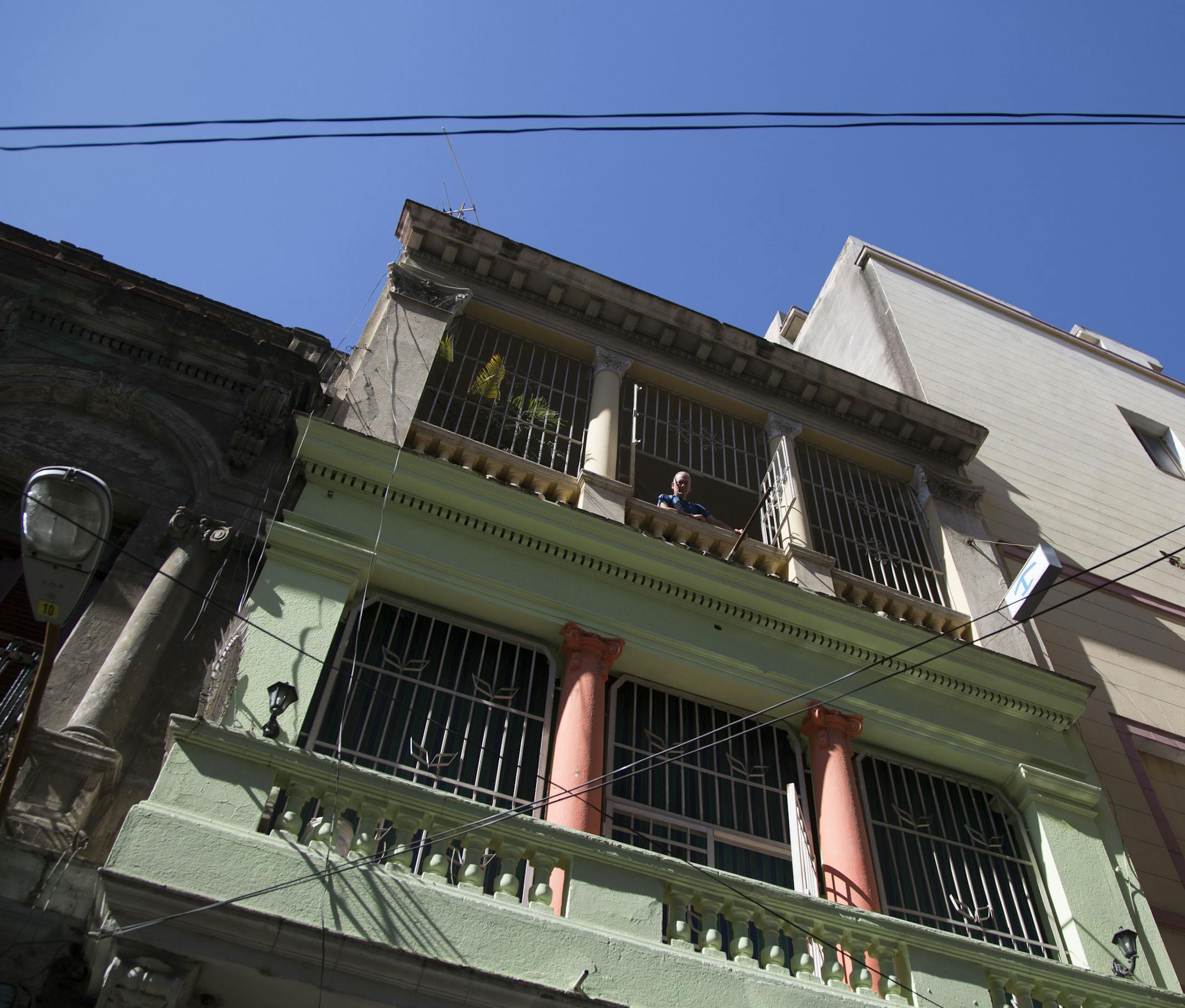 Home owner Israel Rivero looks from his home with rooms for rent in Havana, Cuba, Wednesday, April 1, 2015. The wildly popular online home-sharing service Airbnb will allow American travelers to book lodging in Cuba starting Thursday in the most significant U.S. business expansion on the island since the declaration of detente between the two countries late last year. (AP Photo/Desmond Boylan)