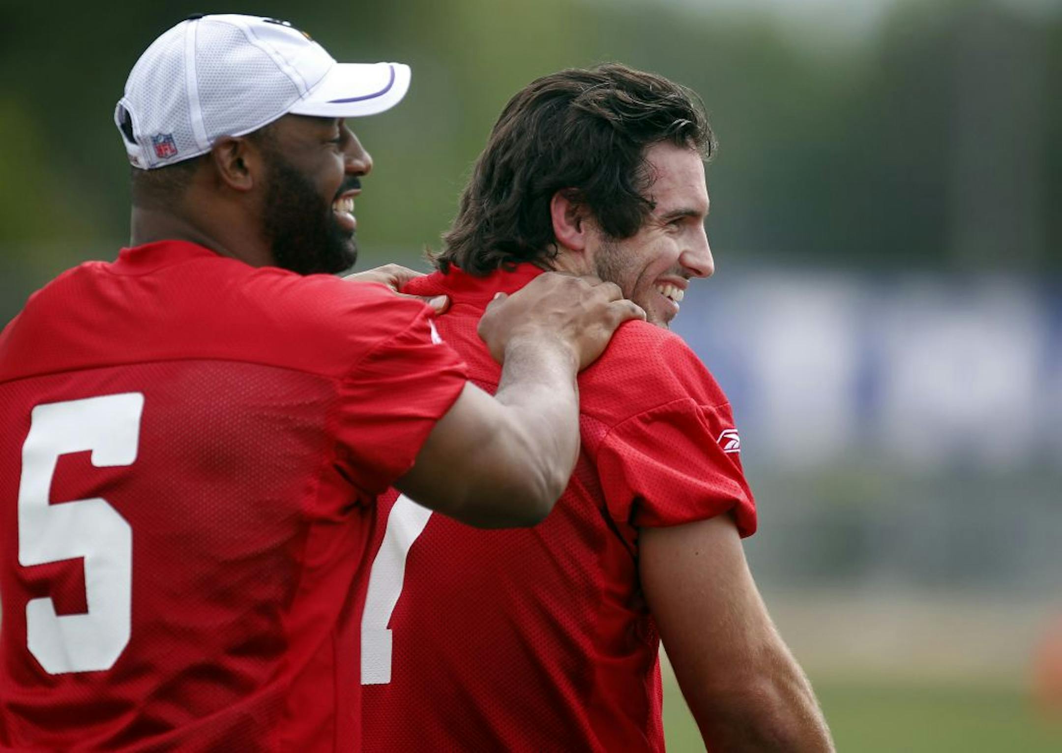Minnesota Vikings quarterback Donovan McNabb (5) joked with Christian Ponder (7) during practice on the first day of Training Camp in Mankato.