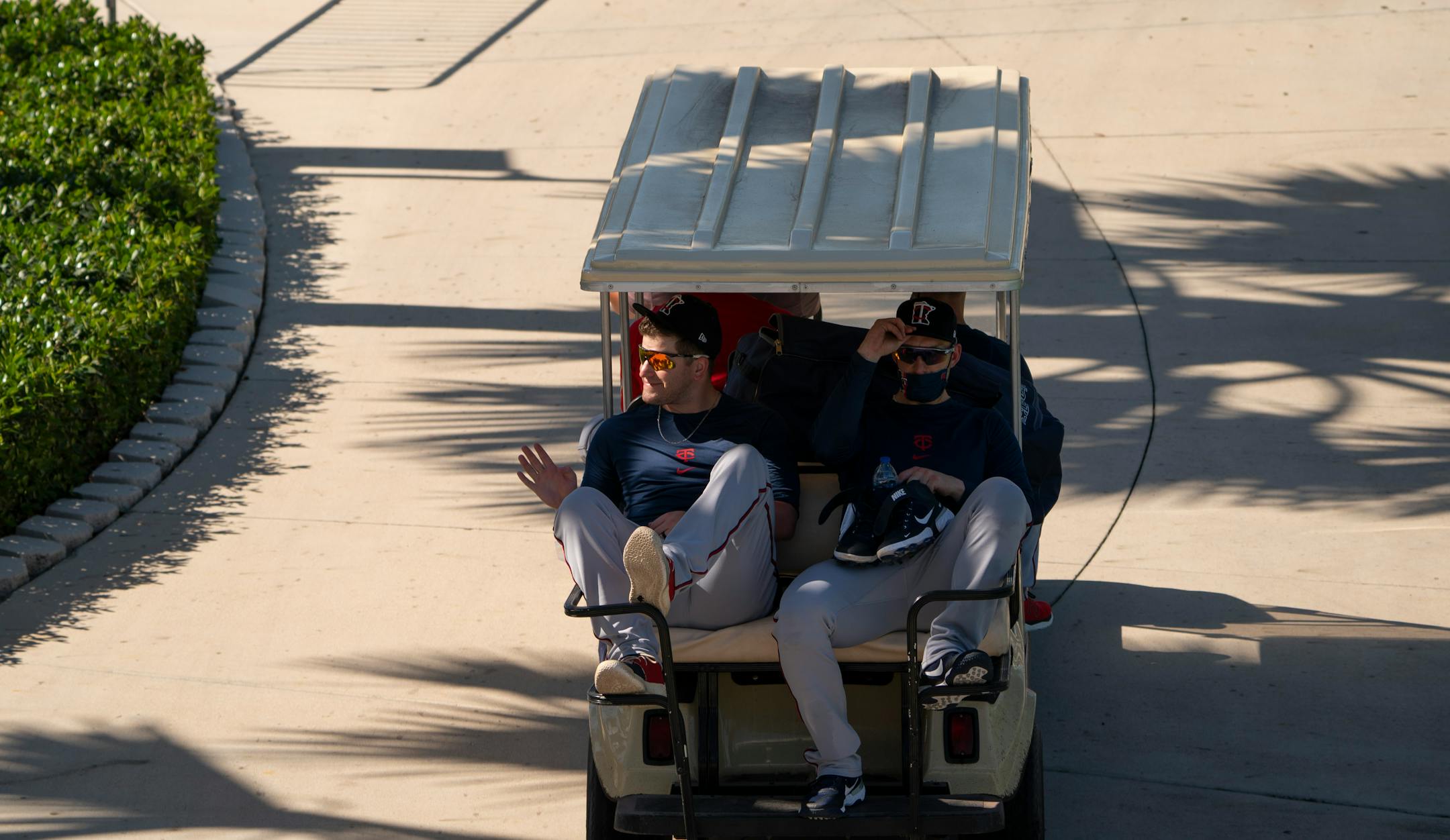 A Twins player waved to a fan while being taxied out to a remote field for the first full squad workout Tuesday morning.