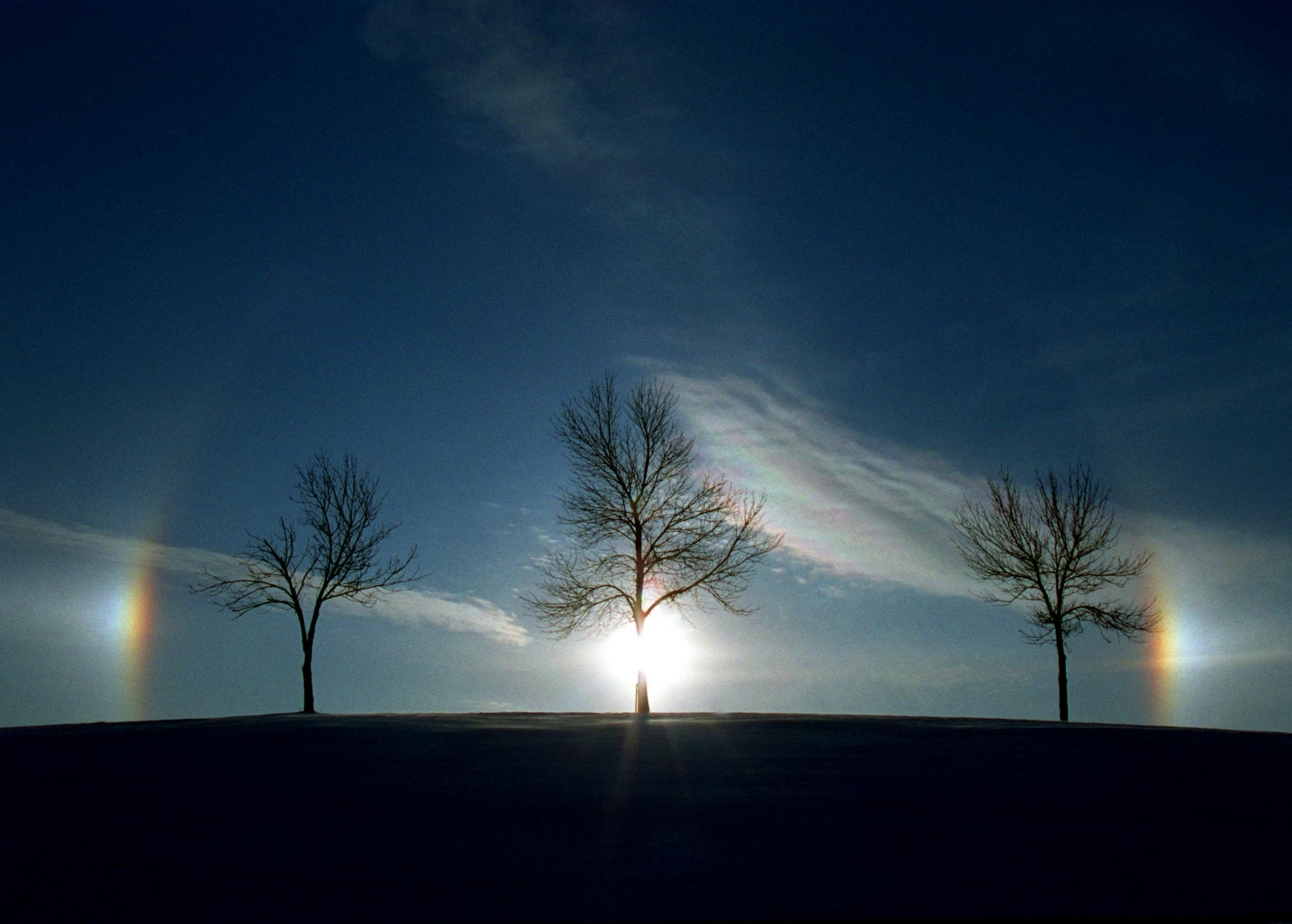 "Who let the sunDOGS out? As the sun crawled into the southeastern sky on the shortest day of the year (Winter Solstice), sundogs, also called mock suns or parhelia, appeared as sunlight refracted through ice crystals in cirroform clouds. Winter Solstice has been celebrated in cultures the world over for thousands of years. This start of the solar year is a celebration of light and the rebirth of the Sun. In old Europe, it was known as Yule, from the Norse, Jul, meaning wheel. Today, many people