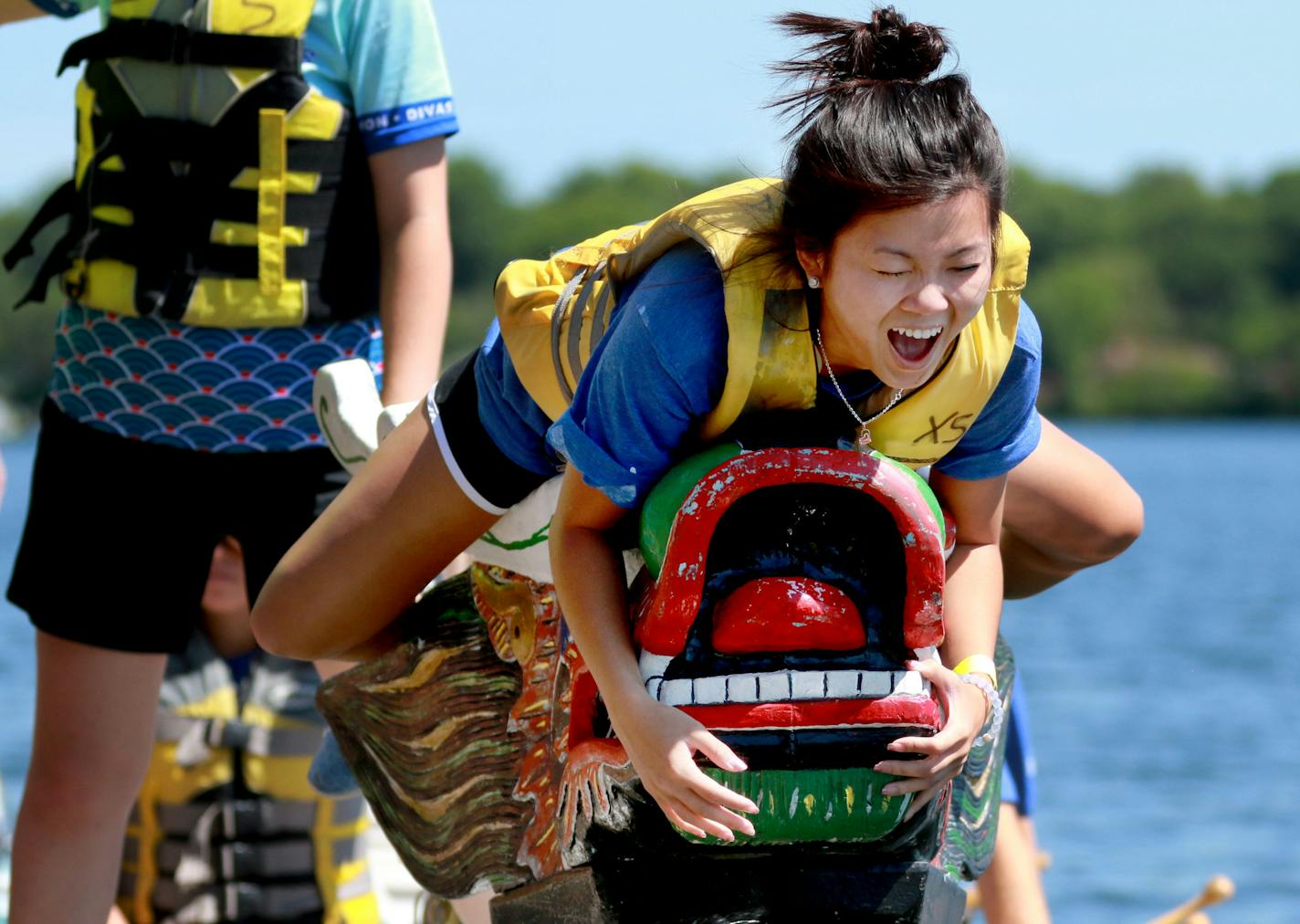 The Dragon Festival 2016, which is a celebration of Pan-Asian heritage and spirit, took place at Lake Phalen Park Saturday, July 9, 2016, in St. Paul, MN. Here, flag catcher Camtu Tran of the Hormel Foods team learns how to position herself near the tip of the boat to grab the flag while being instructed by Miranda Soppeland, not pictured.](DAVID JOLES/STARTRIBUNE)djoles@startribune The Dragon Festival 2016, which is a celebration of Pan-Asian heritage and spirit, took place at Lake Phalen Park