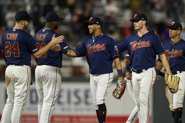 Minnesota Twins players, including left fielder Eddie Rosario (20), center, celebrated their 4-1 win over the Cleveland Indians Saturday night.