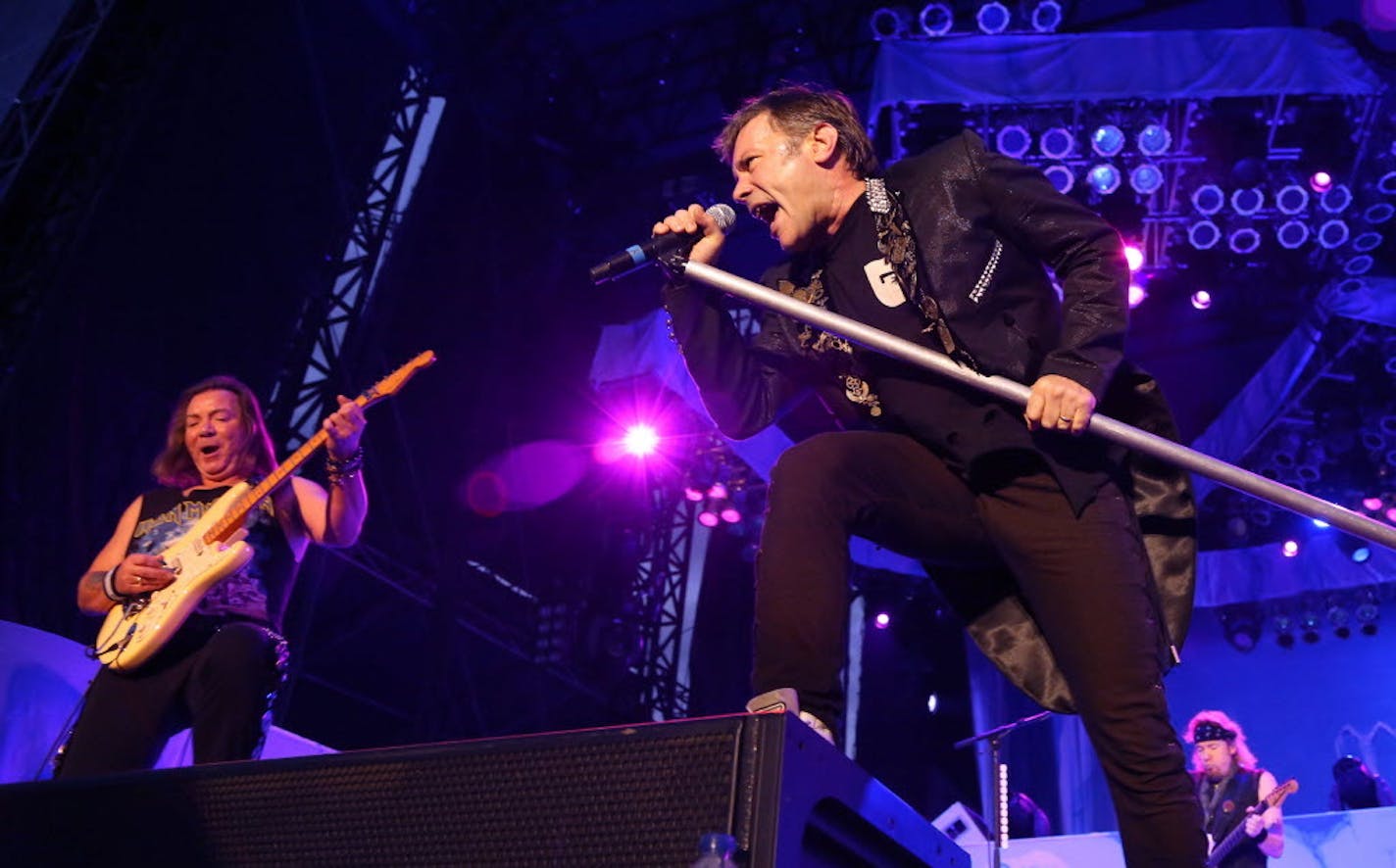 In a photo from 2012, Bruce Dickinson, front, and Dave Murray of Iron Maiden play in Ottawa, Canada.