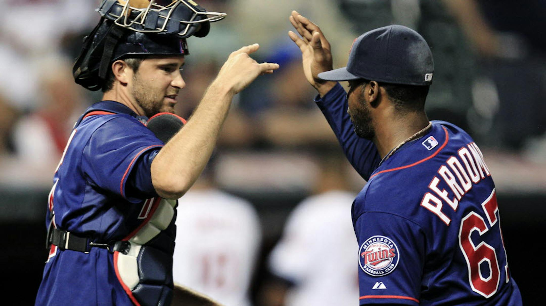 Catcher Ryan Doumit congratulated relief pitcher Luis Perdomo after their 14-3 victory over Cleveland on Aug. 6.
