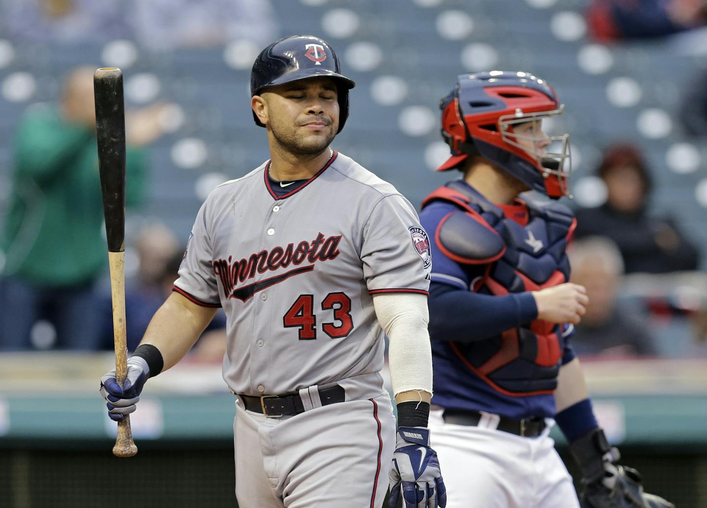 Minnesota Twins' Josmil Pinto walks back to the dugout after striking out against Cleveland Indians starting pitcher T.J. House in the seventh inning of the second game of a baseball doubleheader Thursday, Sept. 11, 2014, in Cleveland. (AP Photo/Mark Duncan)