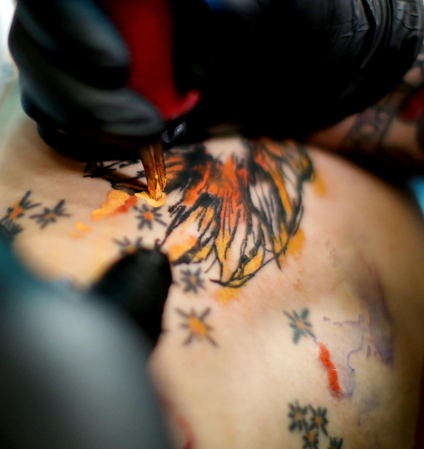 Tattoo artist and shop owner Nikki Time worked on client Abbey Harris, cq, as she got a tattoo at MPLS Tatoo Shop, Monday, July 11, 2016 in Minneapolis, MN. The number of female tattoo artists has soared since '90s, with women accounting for more than a third of artists in Minnesota. ] (ELIZABETH FLORES/STAR TRIBUNE) ELIZABETH FLORES &#x2022; eflores@startribune.com