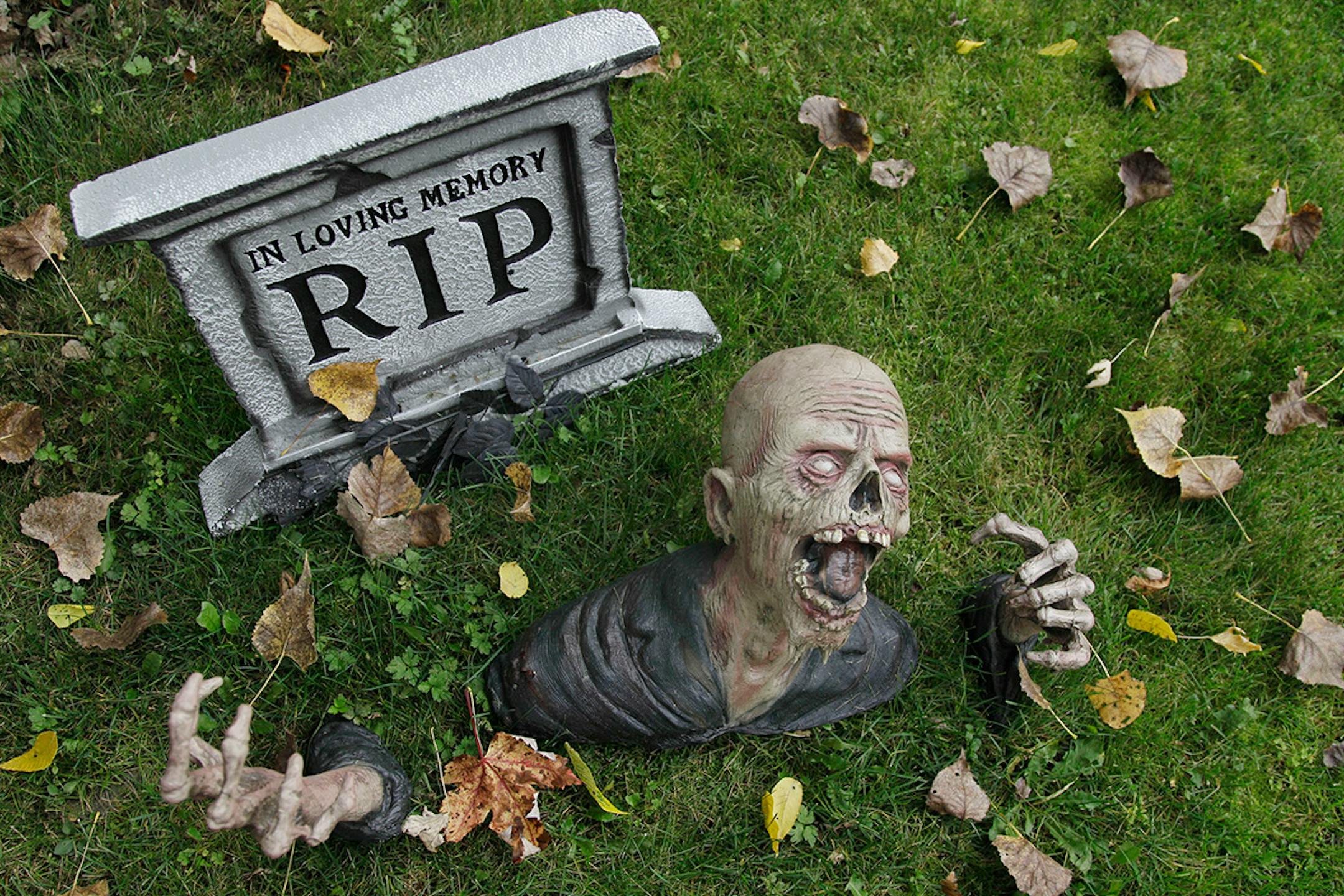 FILE - This Oct. 5, 2012 file photo shows a Halloween display in a front yard of a residence during the windy weather in Pembroke, N.Y. Despite warnings about tainted candy, candle fires and even child abductions, real Halloween headlines are rarely about any of those things. Instead, tragedies related to the holiday typically involve trick-or-treaters hit by cars. A study published in 2010 in the Journal of the American Academy of Pediatrics found that the most emergency room visits involving c