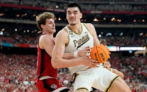 Purdue center Zach Edey backs down NC State forward Ben Middlebrooks during the second half Saturday's Final Four semifinal.