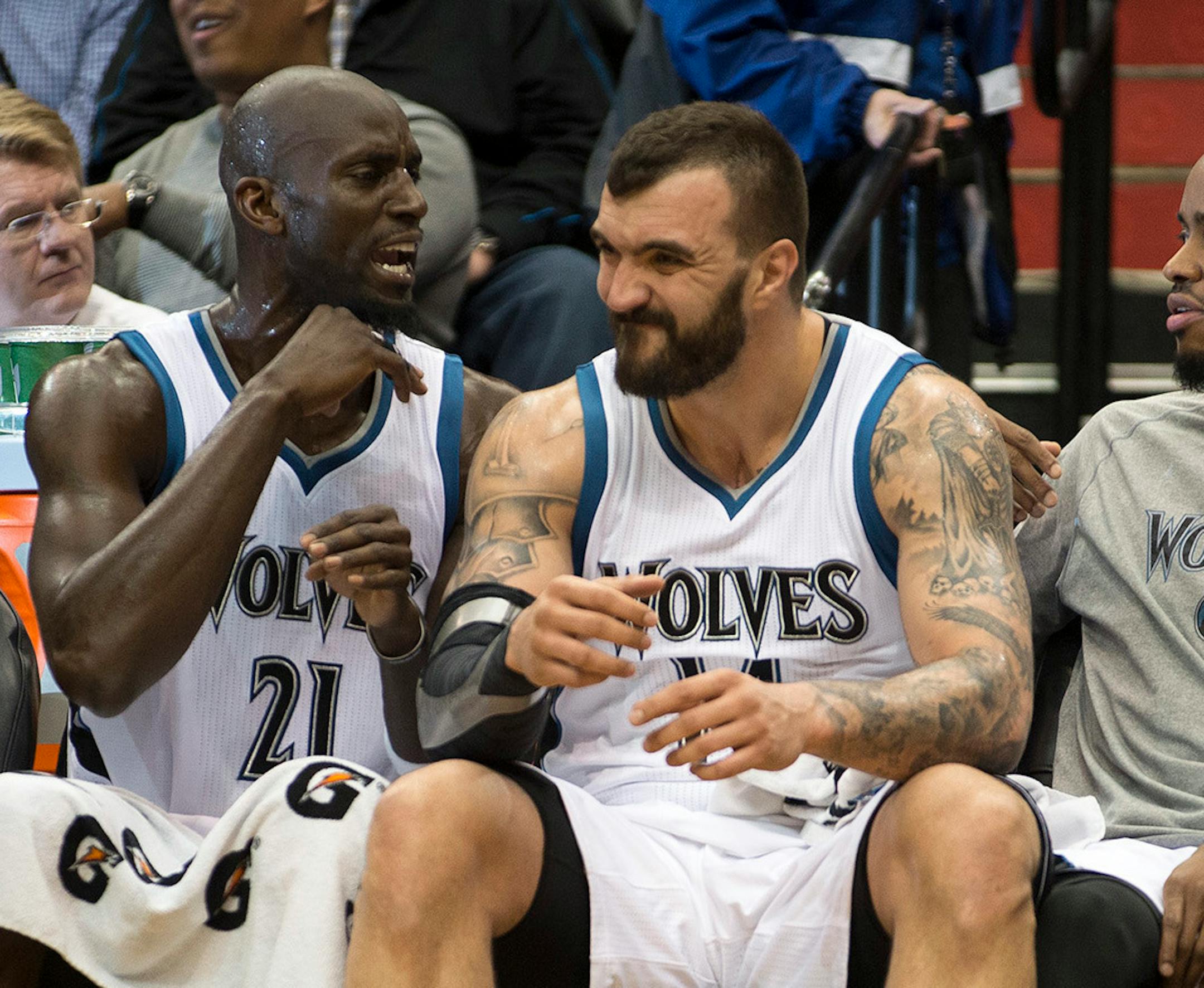 Minnesota Timberwolves forward Kevin Garnett (21) talks to center Nikola Pekovic (14) as he winces in pain on the bench in the second half. ] (Aaron Lavinsky | StarTribune) The Minnesota Timberwolves play the Denver Nuggets on Wednesday, March 4, 2015 at Target Center.