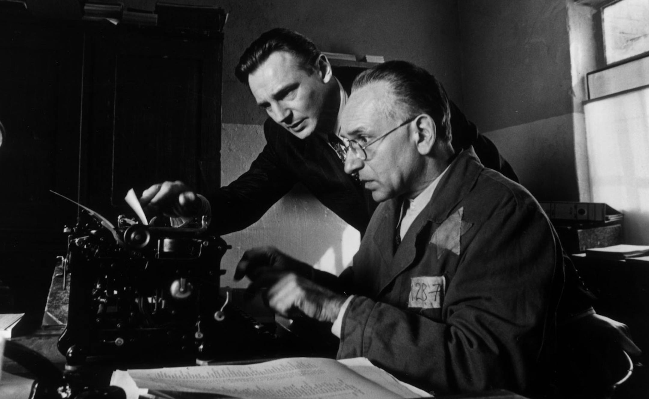 1993 movie SCHINDLER'S LIST / German industrialist Oskar Schindler (played by Liam Neeson, at left) and Jewish accountant Itzhak Stern (played by Ben Kingsley, right) assemble the list of more than 1,100 Jewish workers to be placed under Schindler's protection. Photo by David James, courtesy of Universal Pictures. ORG XMIT: MIN2013021815281737