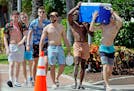Beachgoers carry a cooler down Poinsettia Street during Spring Break on Fort Lauderdale Beach, Fla., on Tuesday, March 8, 2022. (Amy Beth Bennett/Sout