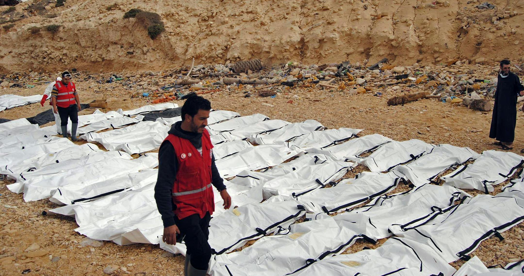 This Monday, Feb. 20, 2017 photo provided by The International Federation of Red Cross and Red Crescent Societies (IFRC), shows bodies of people that washed ashore and were recovered by the Libyan Red Crescent, near Zawiya, Libya. The Libyan Red Crescent says at least 74 bodies of African migrants have washed ashore in western Libya, the latest tragedy at sea along a perilous trafficking route to Europe. It says the bodies were found on Monday, and that more may yet surface. (Mohannad Karima/IFR