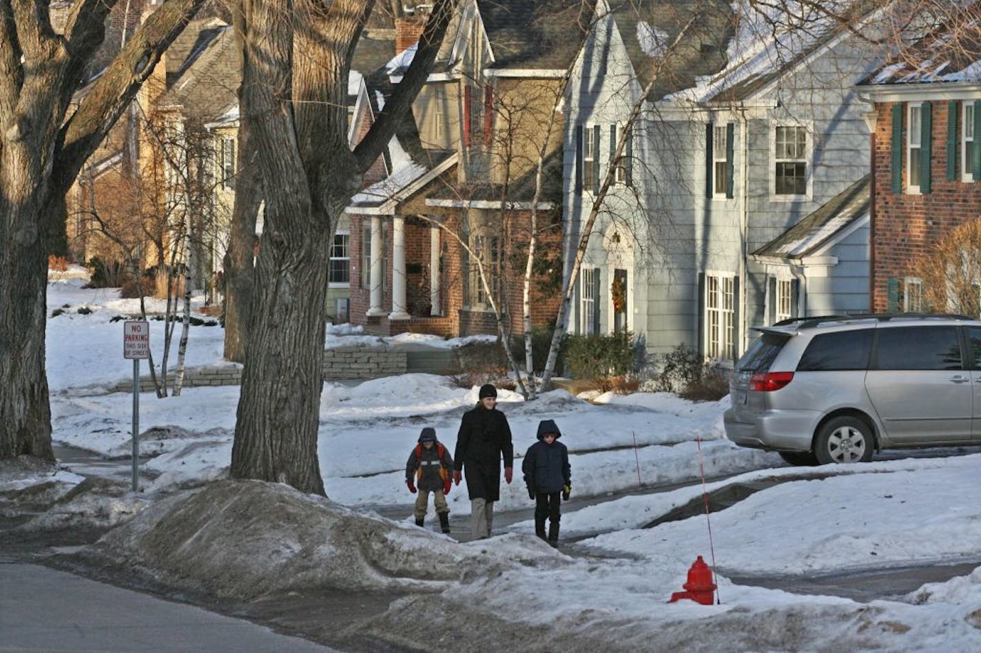 Peter Rehkamp-Larson, Jean Rehkamp-Larson and Andrew Rehkamp-Larson walked home from the bus stop in the 4200 block of Arden Ave. South.