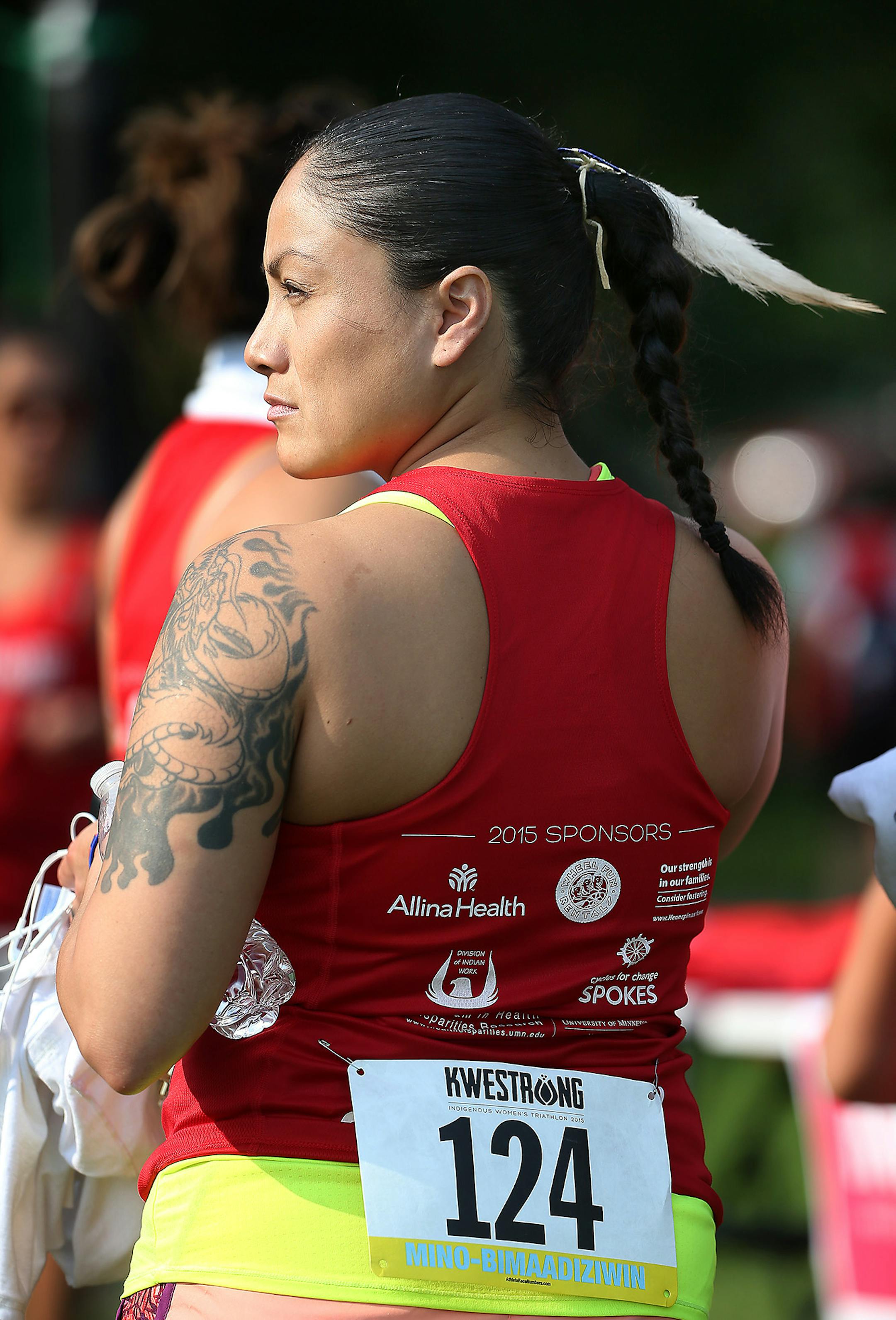 Monica Flores, a member of the Lakota Nation and who brought a group of women from North Dakota, wore a feather during the 2015 KWESTRONG women's triathlon, Saturday, August 22, 2015 in Minneapolis, MN. ] (ELIZABETH FLORES/STAR TRIBUNE) ELIZABETH FLORES • eflores@startribune.com