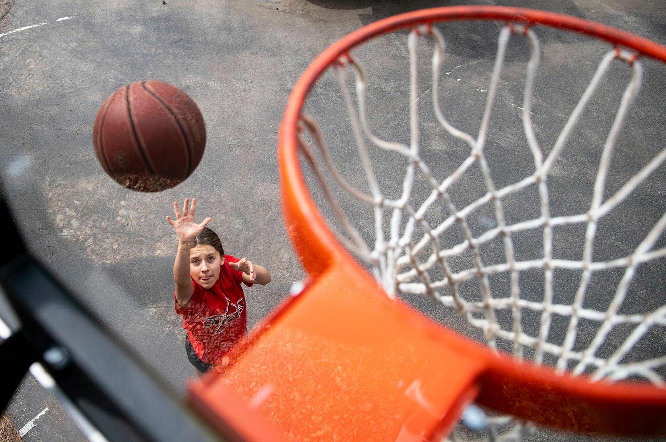Quinn Danielson, 13, practiced her layup skills in her front yard. "I don't want [the virus] to come here to my family, to my friends and around here," Quinn said. But whenever she feels frustrated by the state of things she likes to get outside. "I play basketball, I workout, I go for runs and I bake a lot," she said. Quinn plays point guard for the local Cloquet girl's basketball team and loves it more than any other activity.