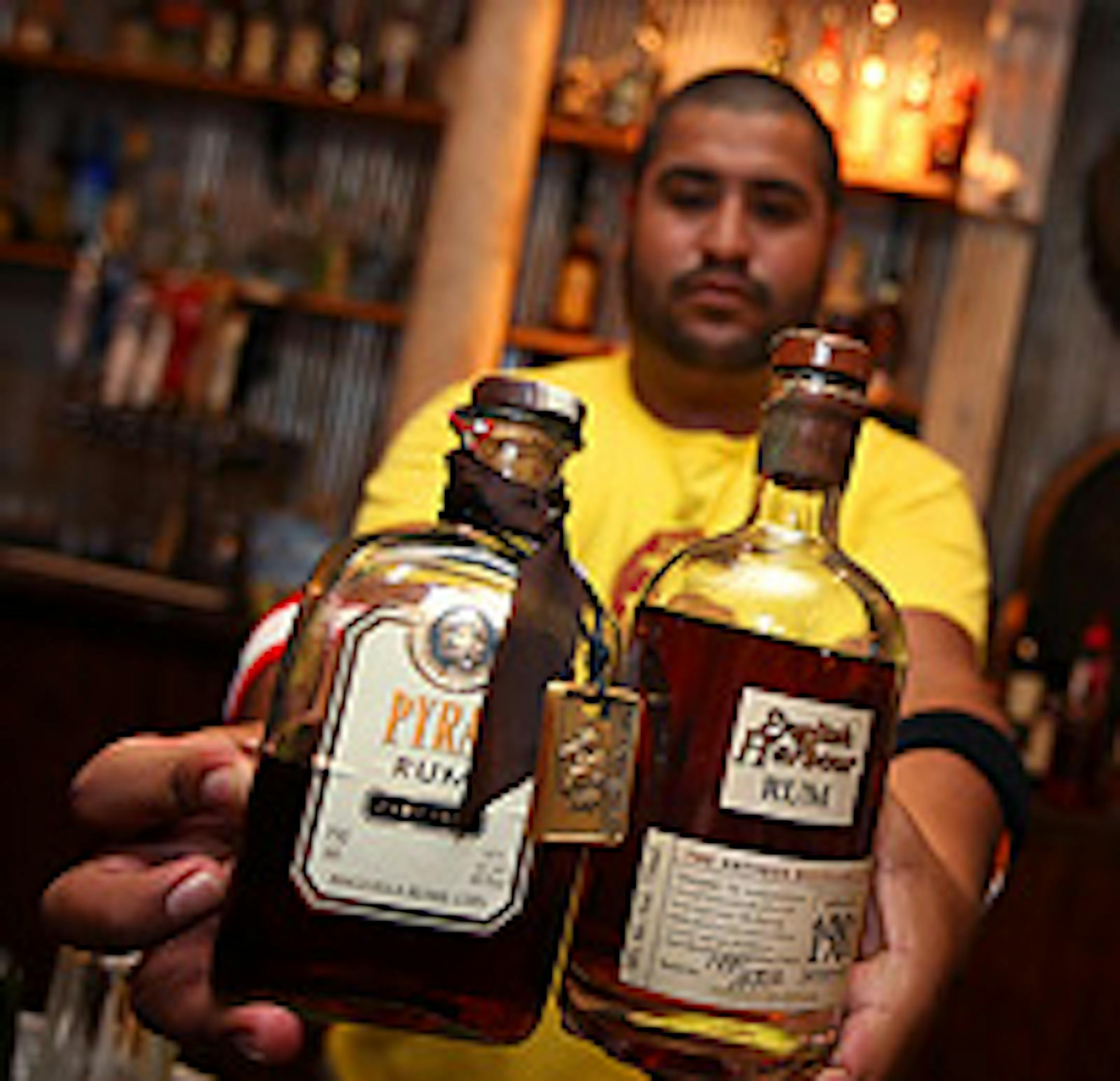 Barman Raul Saud exhibits the two top Rums: Pyrat at $45 a shot and English Harbour at $50 a shot.