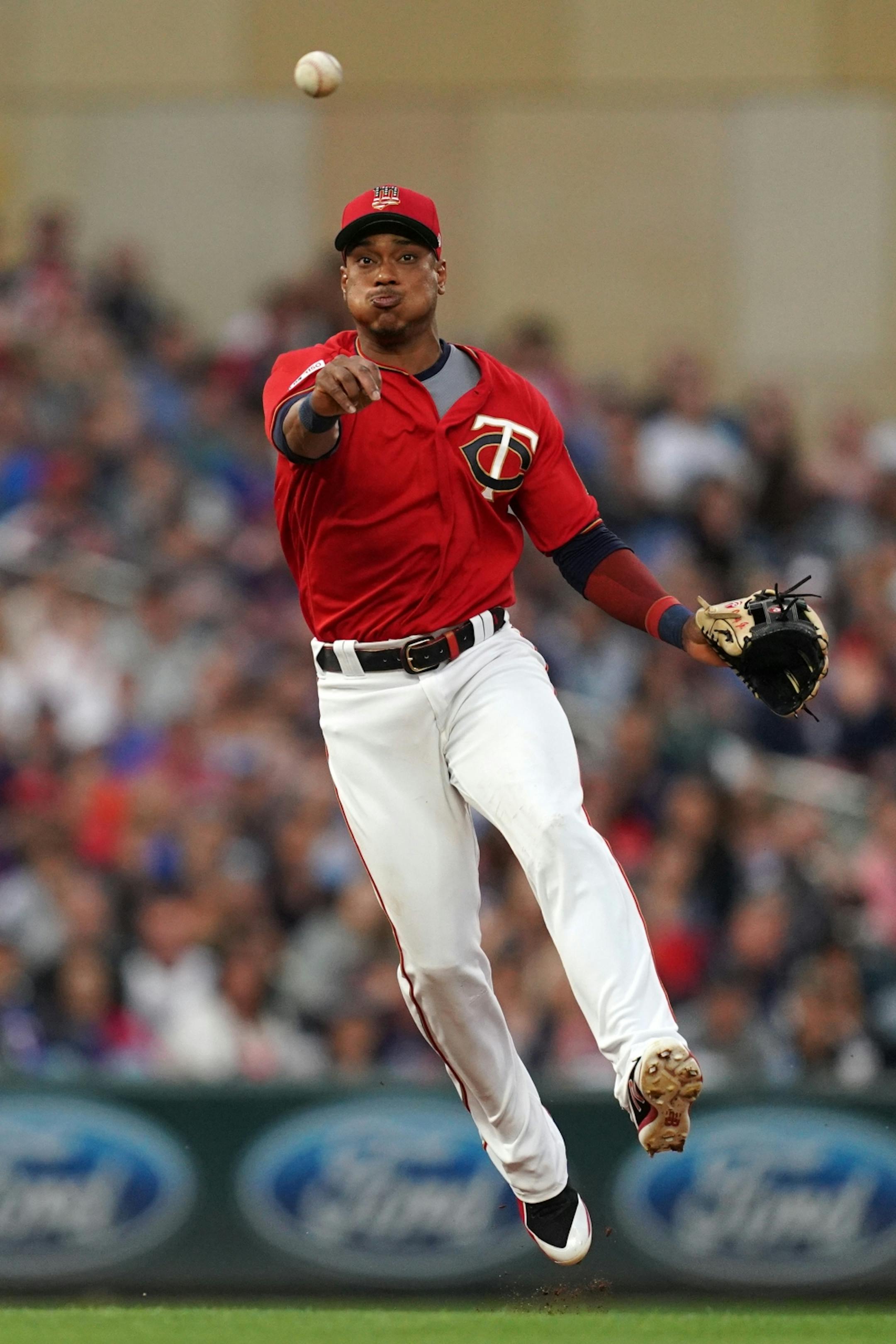Minnesota Twins shortstop Jorge Polanco (11) fielded a ball hit by Texas Rangers center fielder Delino DeShields (3) in the first inning.