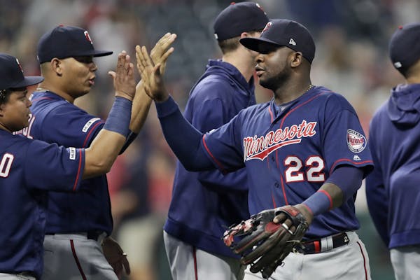 Minnesota Twins' Miguel Sano is congratulated by teammates after they defeated the Cleveland Indians in the second baseball game of a doubleheader, Sa