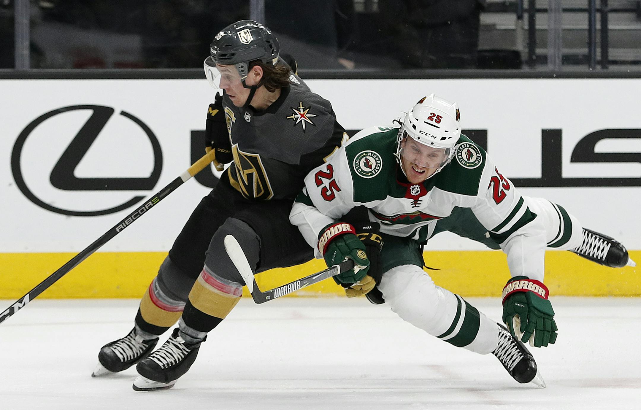 Vegas Golden Knights left wing Erik Haula, left, skates around Minnesota Wild defenseman Jonas Brodin during the third period of an NHL hockey game Friday, March 16, 2018, in Las Vegas. The Wild won 4-2. (AP Photo/John Locher)
