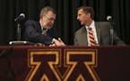 Mark Coyle, right, shakes hands with Minnesota President Eric Kaler after a news conference at which Coyle was introduced as the university's new athl